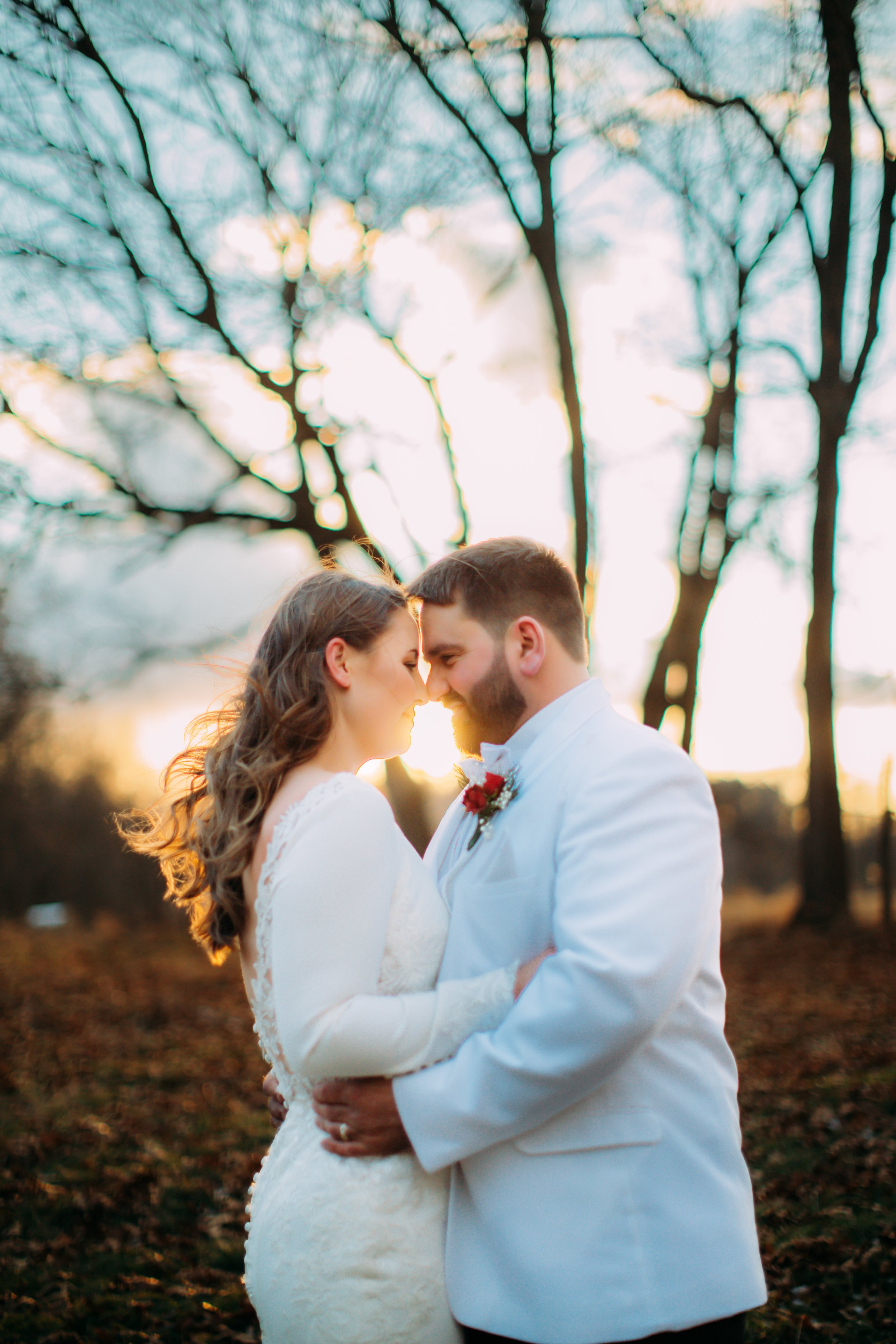  In LaSalle, Illinois a bride and groom hug with the sun setting behind them captured by Teala Ward Photography. sunset bridal pic #TealaWardPhotography #TealaWardWeddings #LaSalleWedding #churchwedding #Illinoisweddingphotographer #LaSalle,IL 