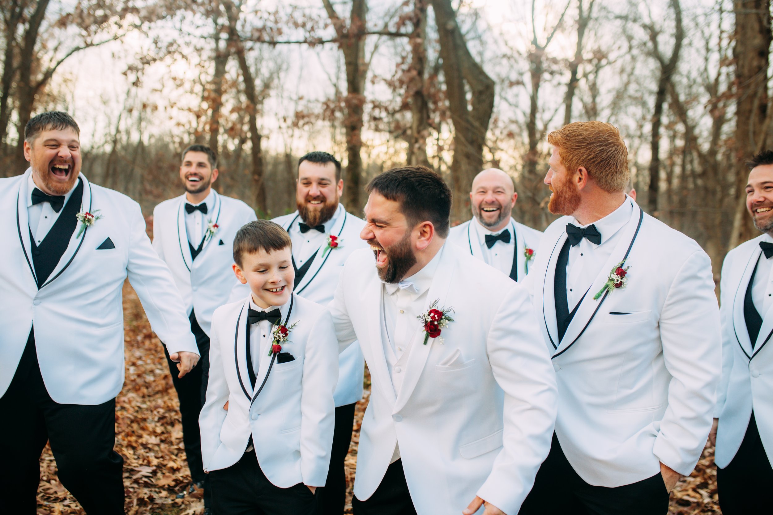  Groom in all white laughing with his groomsmen by Teala Ward Photography in Illinois. groomsmen portrait white suits #TealaWardPhotography #TealaWardWeddings #LaSalleWedding #churchwedding #Illinoisweddingphotographer #LaSalle,IL 
