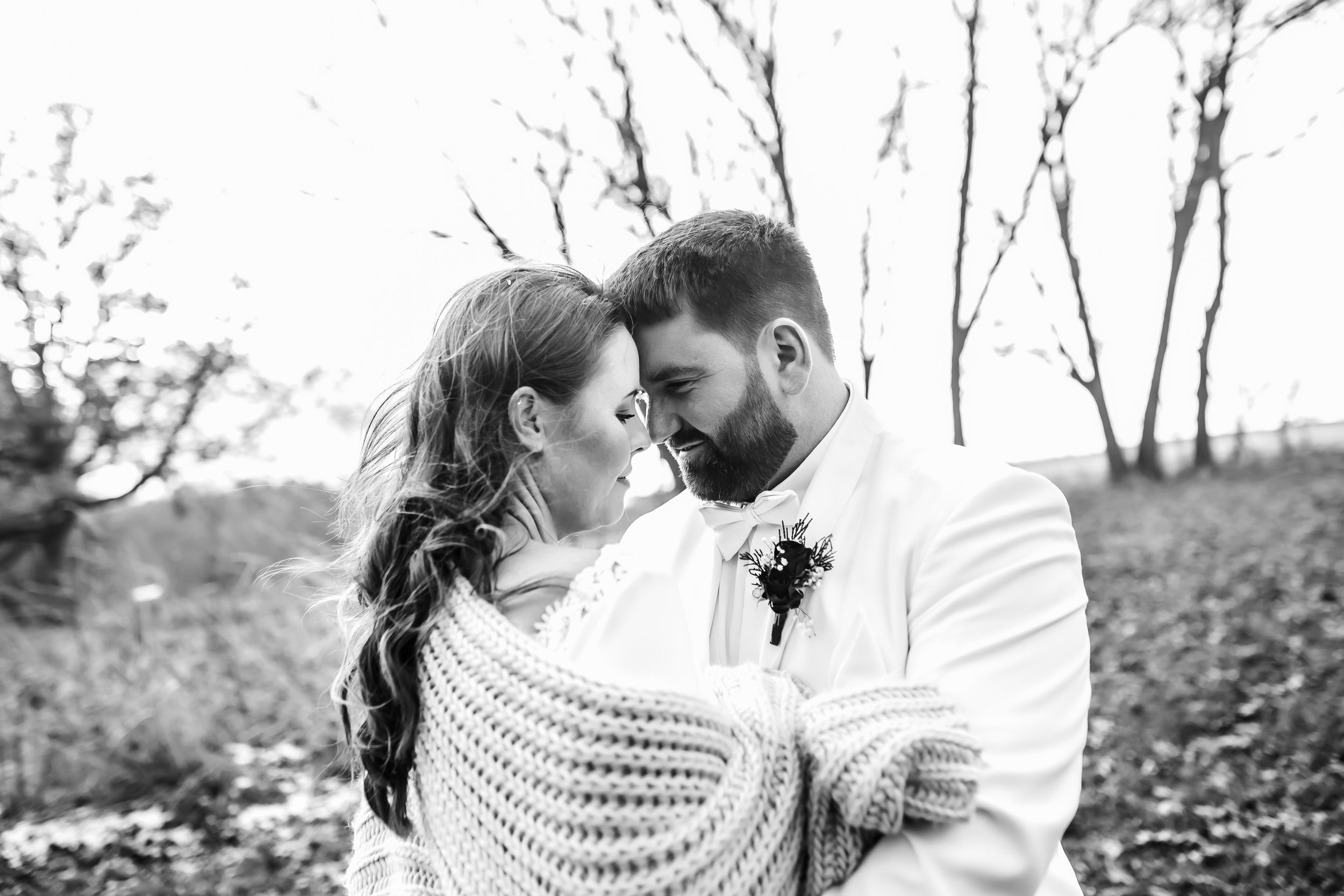  A black and white portrait of a bride and groom snuggled in a blanket with heads together by Teala Ward Photography. blanket bride #TealaWardPhotography #TealaWardWeddings #LaSalleWedding #churchwedding #Illinoisweddingphotographer #LaSalle,IL 