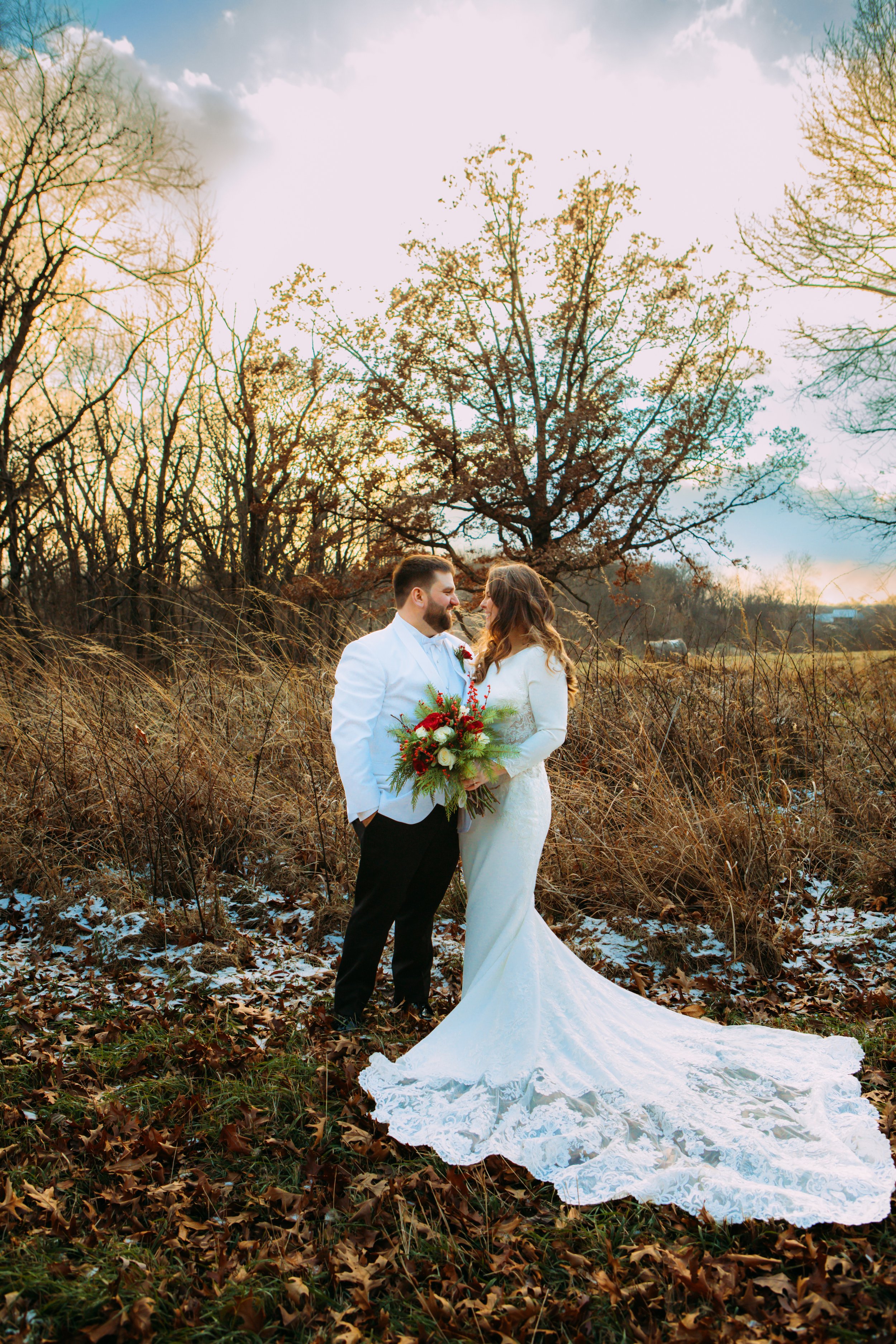  In a winter field in Illinois, a bride and groom look into each other's eyes by Teala Ward Photography. wedding day portraits #TealaWardPhotography #TealaWardWeddings #LaSalleWedding #churchwedding #Illinoisweddingphotographer #LaSalle,IL 