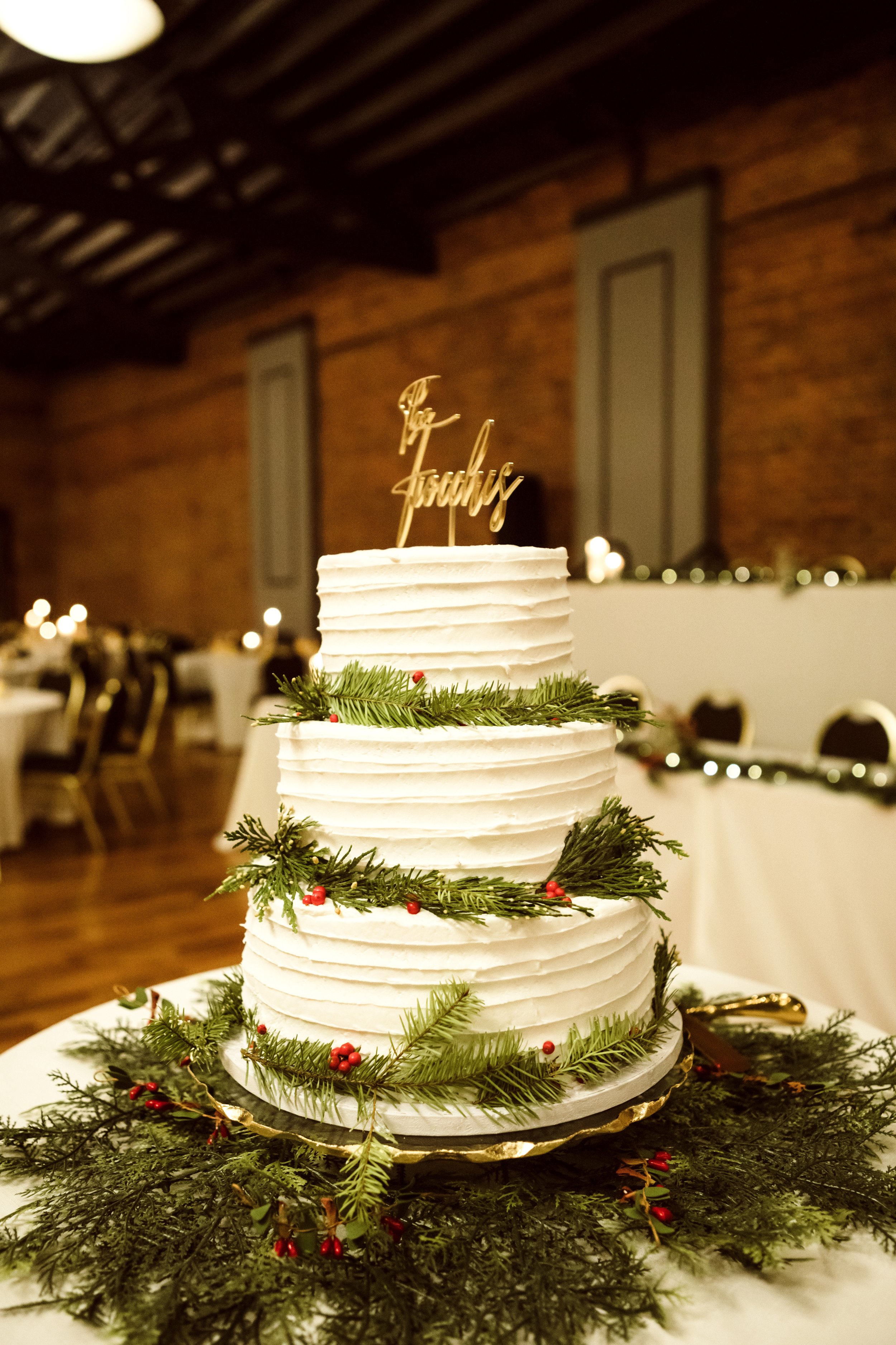  Three-tier buttercream wedding cake with winter greenery by Teala Ward Photography. winter wedding cake three tier simple #TealaWardPhotography #TealaWardWeddings #LaSalleWedding #churchwedding #Illinoisweddingphotographer #LaSalle,IL 