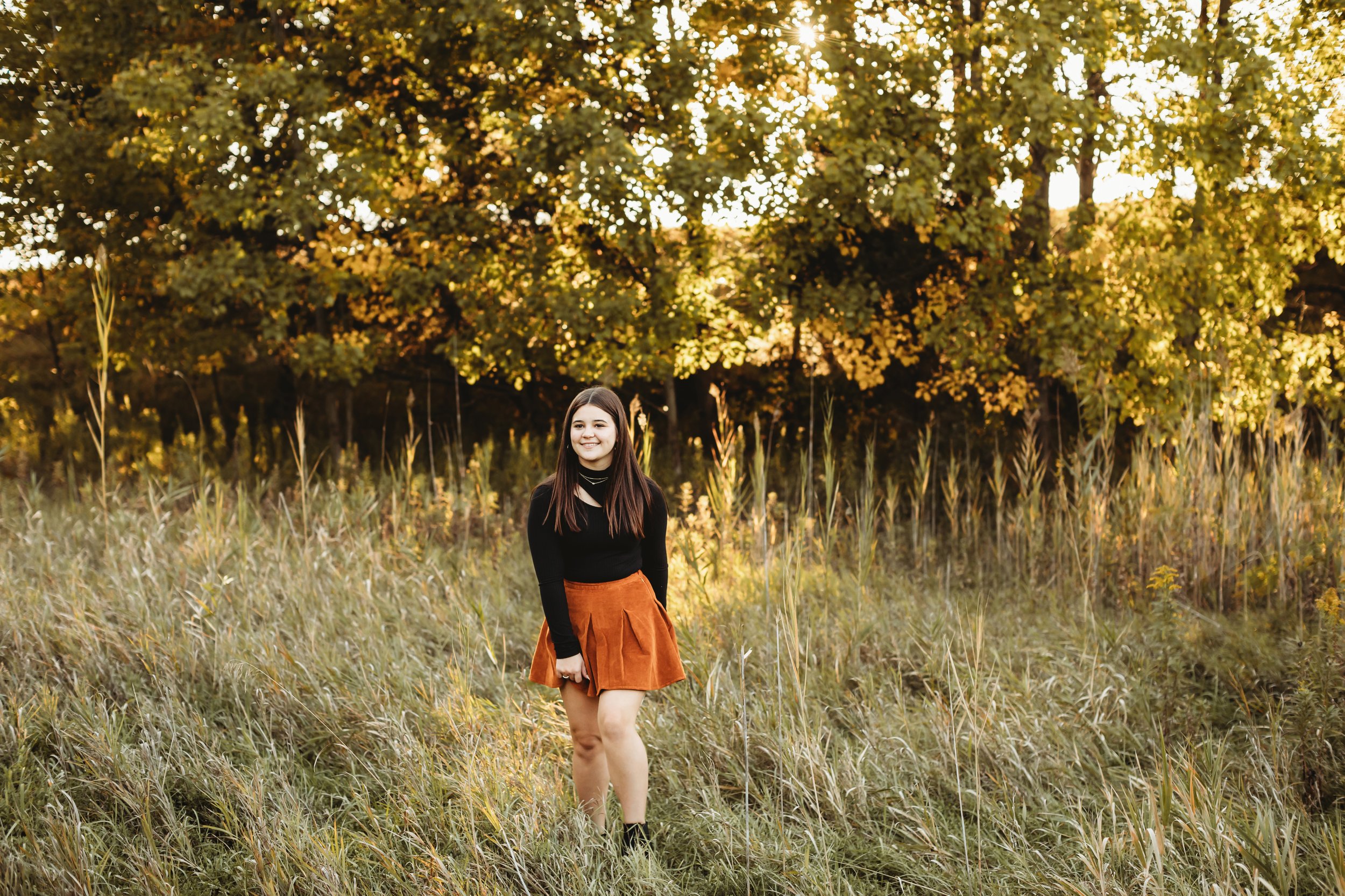  Portrait of a teenage girl wearing an orange skirt and black shirt in a yellow grass field in Buffalo Rock, IL by Teala Ward Photography. teenage girl style skirt #TealaWardPhotography #TealaWardFamilies #Outdoorfamilyportraits #IllinoisPhotographer