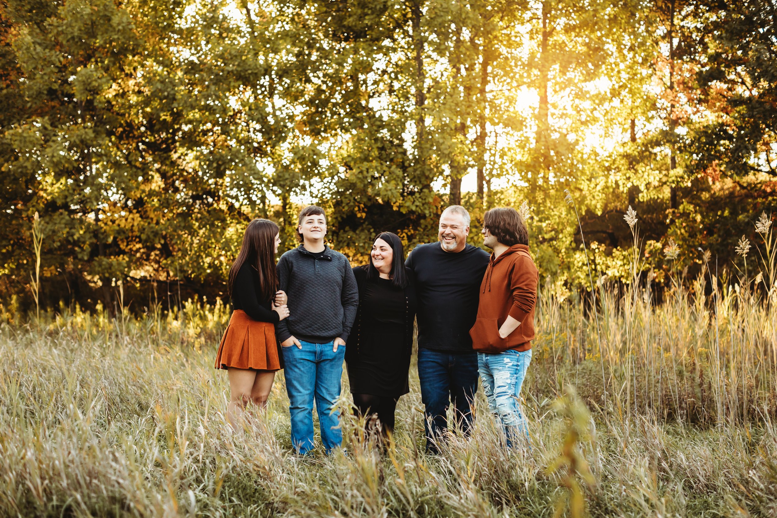  Teala Ward Photography captures a family portrait with one daughter and two sons all teenagers. Black and orange outfits warm bright teenagers spring family portraits #TealaWardPhotography #TealaWardFamilies #Outdoorfamilyportraits #IllinoisPhotogra