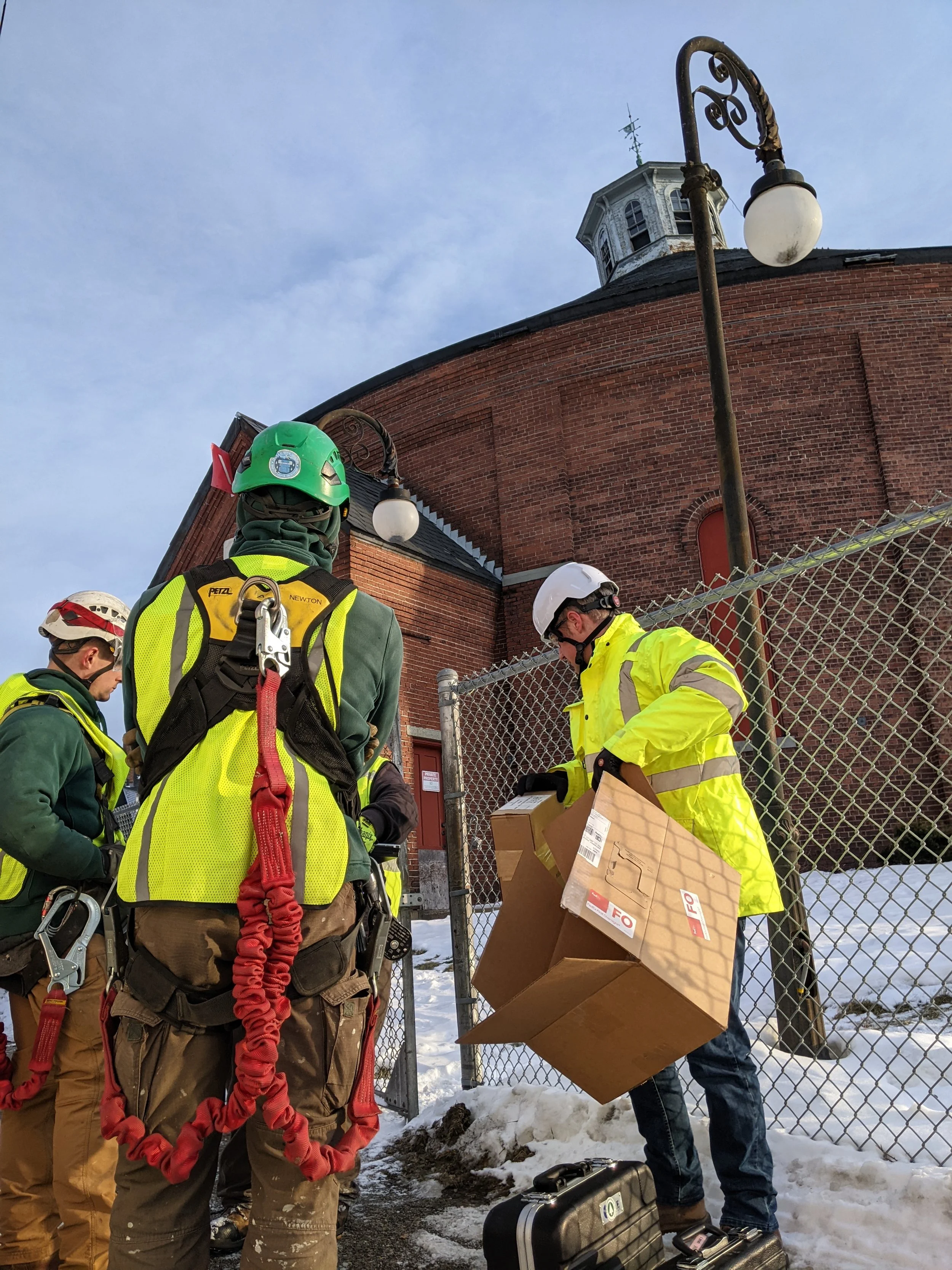 Gasholder team members don protective equipment before entering the building in Dec 2025