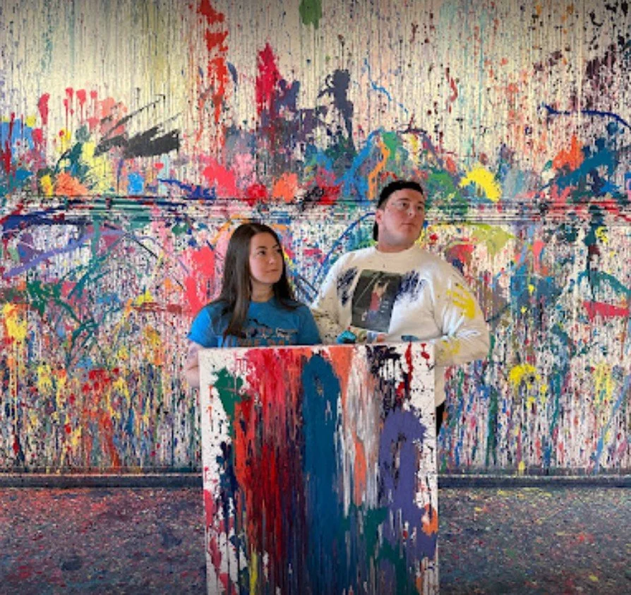 Couple making a funny face during their personal photoshoot at Splatter Charlotte while on a date.