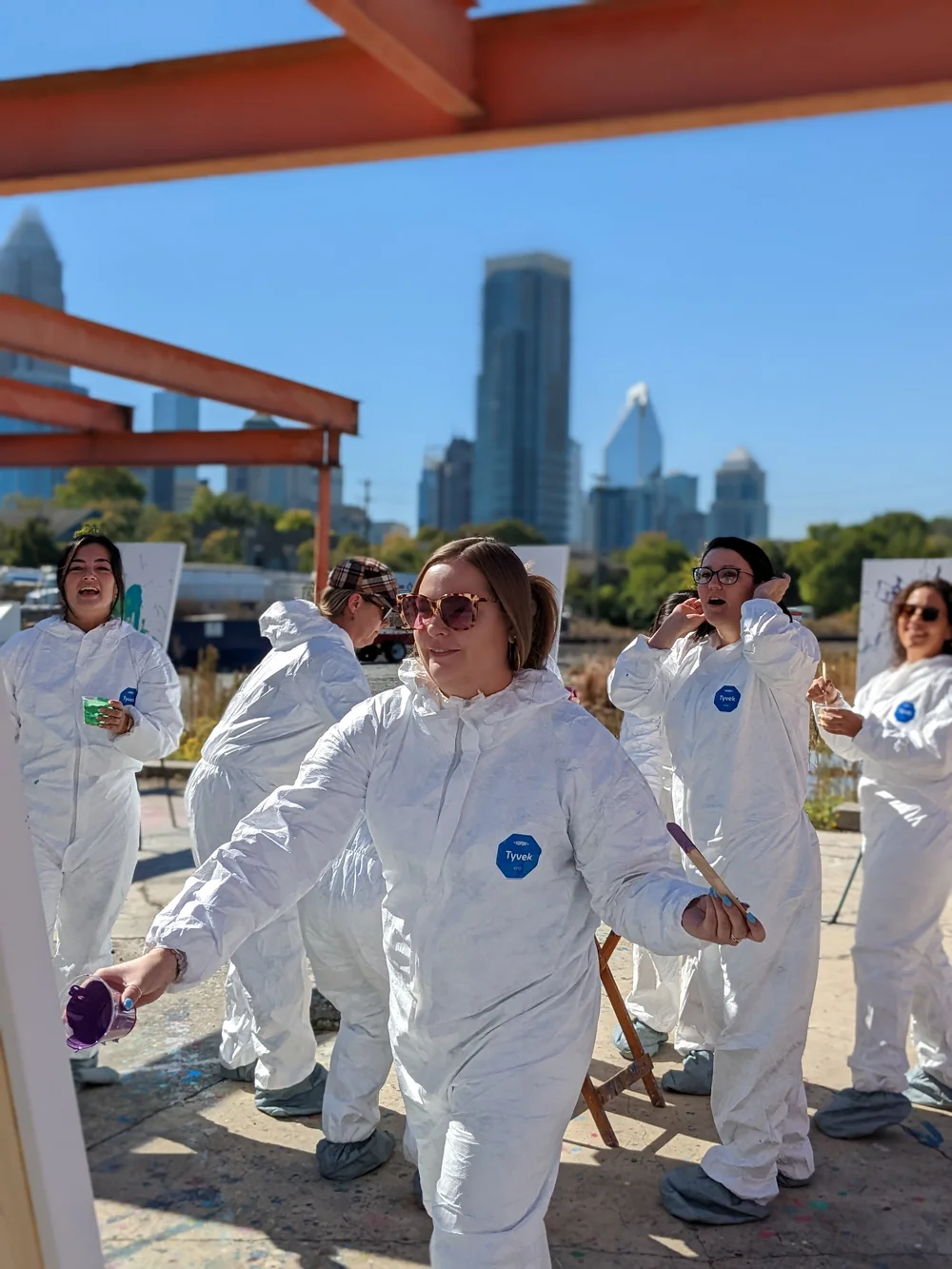 Coveralls on a rooftop deck, uptown behind them.