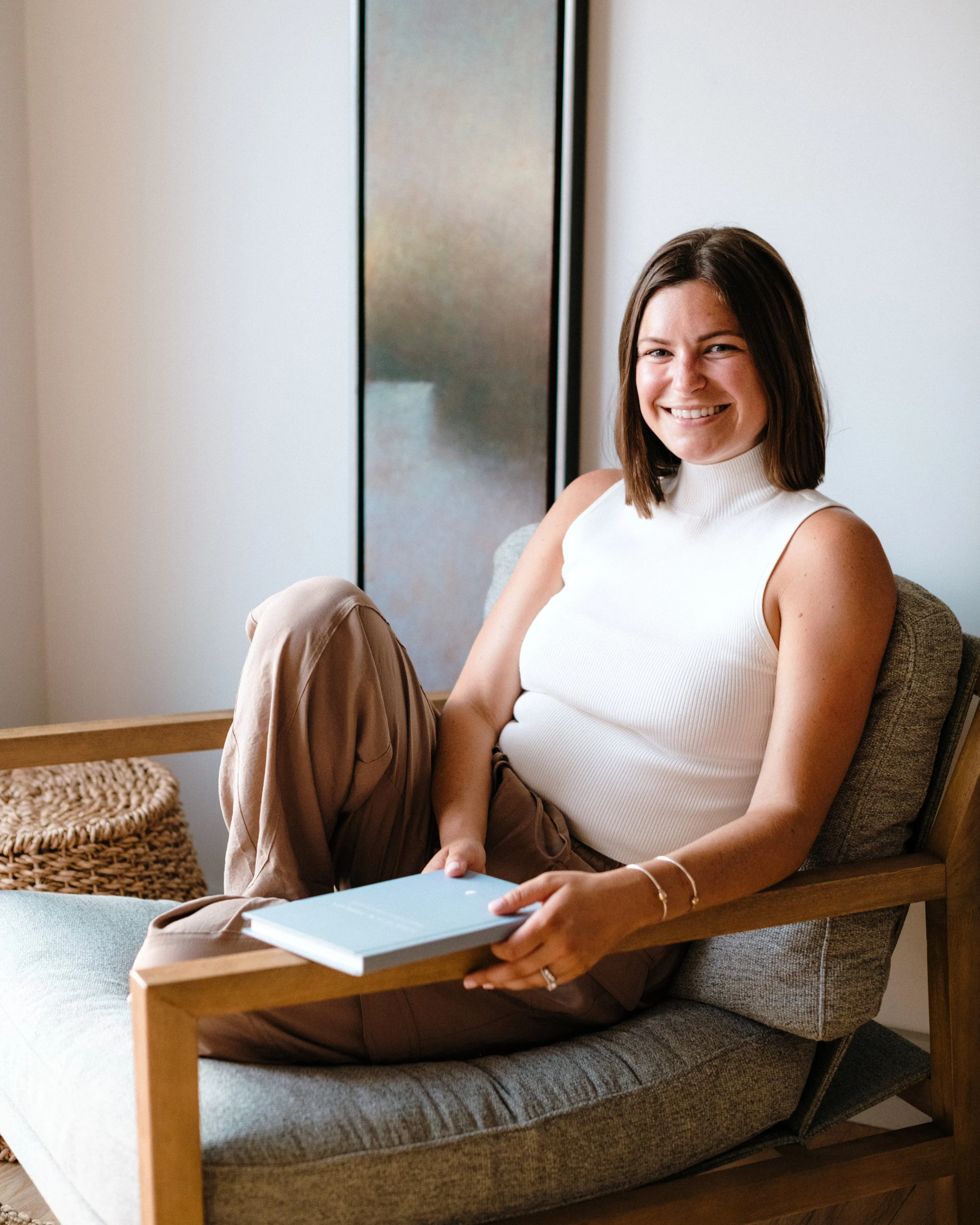 Practice founder, Heidi Hulbig, sitting in a chair during a therapy session.