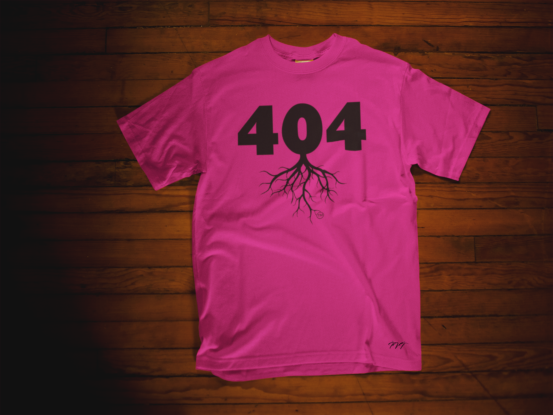 T-SHIRT MOCKUP OF A 404 AREA CODE PINK (BLACK) T-SHIRT LYING OVER A WOODEN SURFACE.png