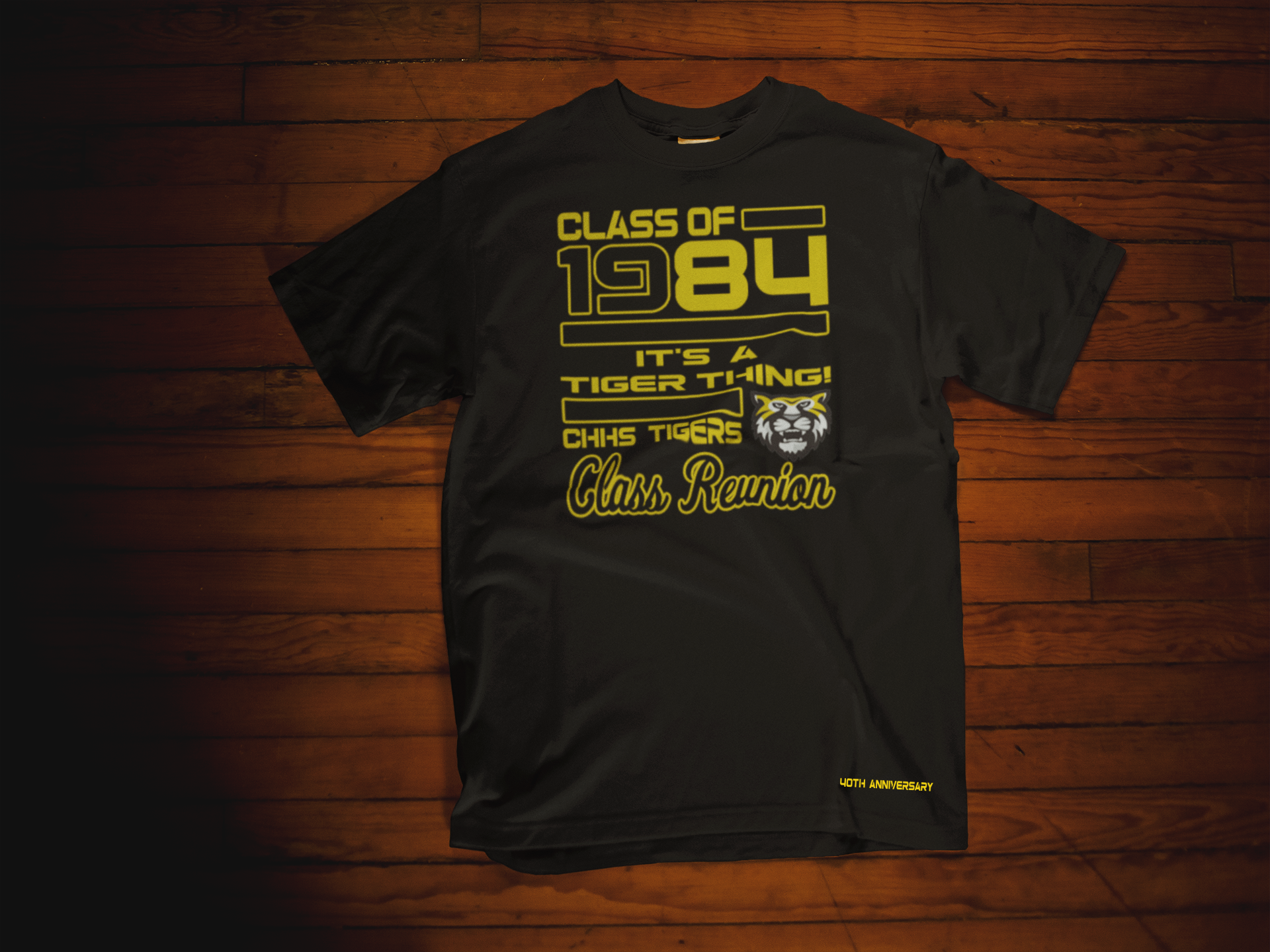T-SHIRT MOCKUP OF A CHHS REUNION BLACK T-SHIRT LYING OVER A WOODEN SURFACE.png