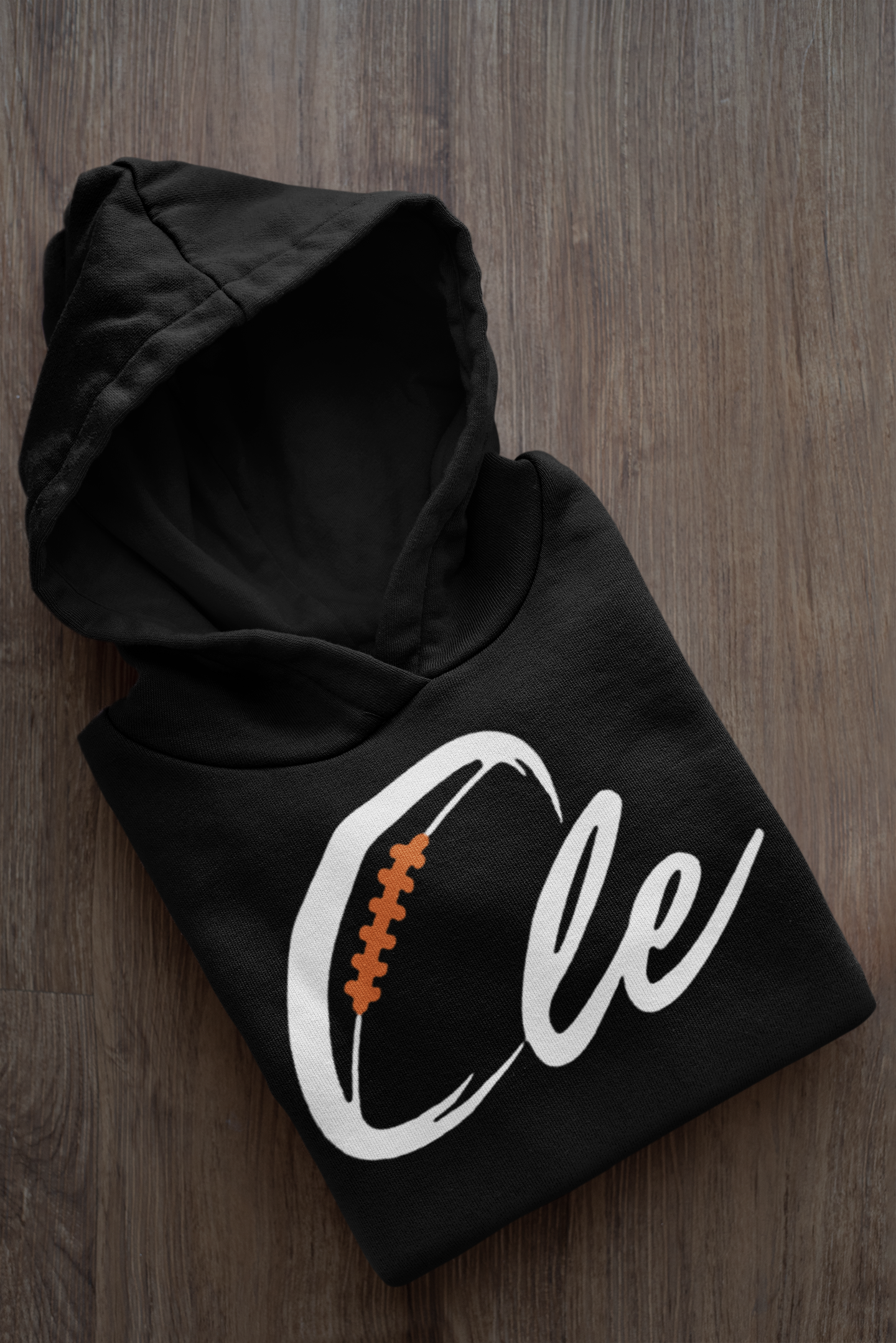 mockup-of-a-folded-customizable-hoodie-placed-on-a-wooden-surface-33874a.png