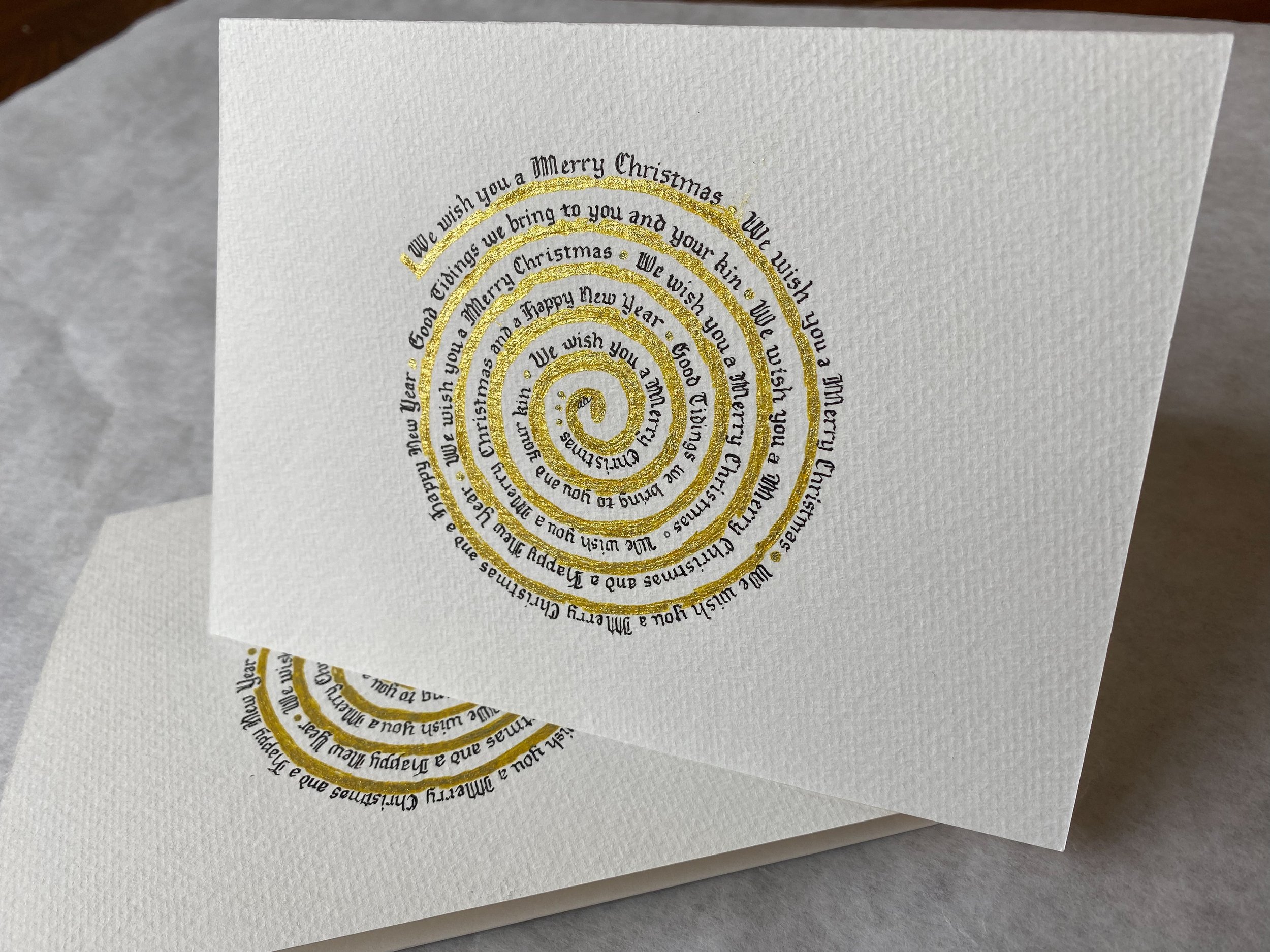 Gothic lettering on spiral. Gothic can add a historical weight to a design. Guests are often amazed this style is hand written given the crisp lines and shapes in the letters. 