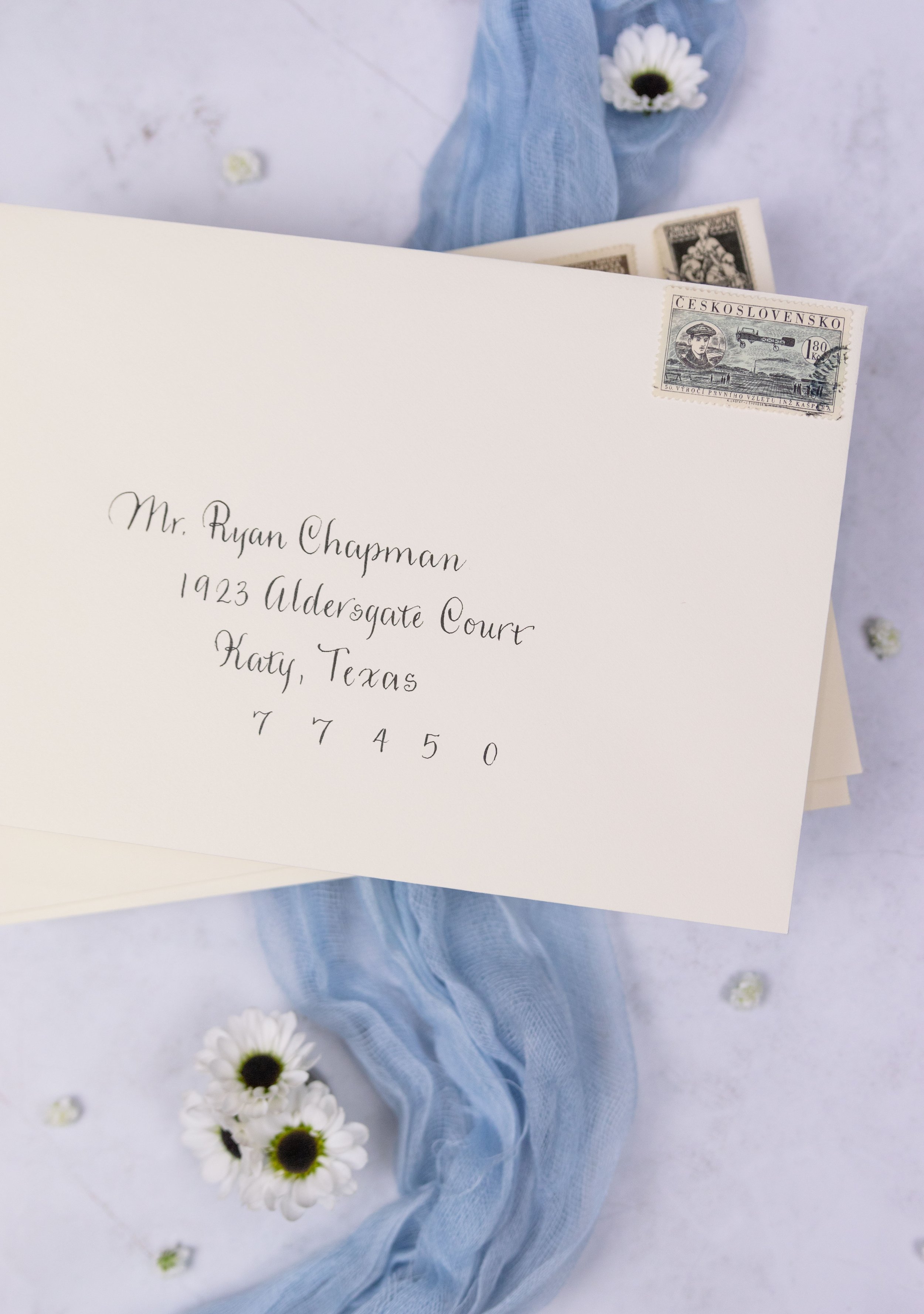 Envelopes addressed with a modern calligraphy style. 