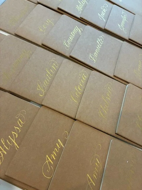 Hand foiled names on notebooks for high touch wellness retreat in Texas.