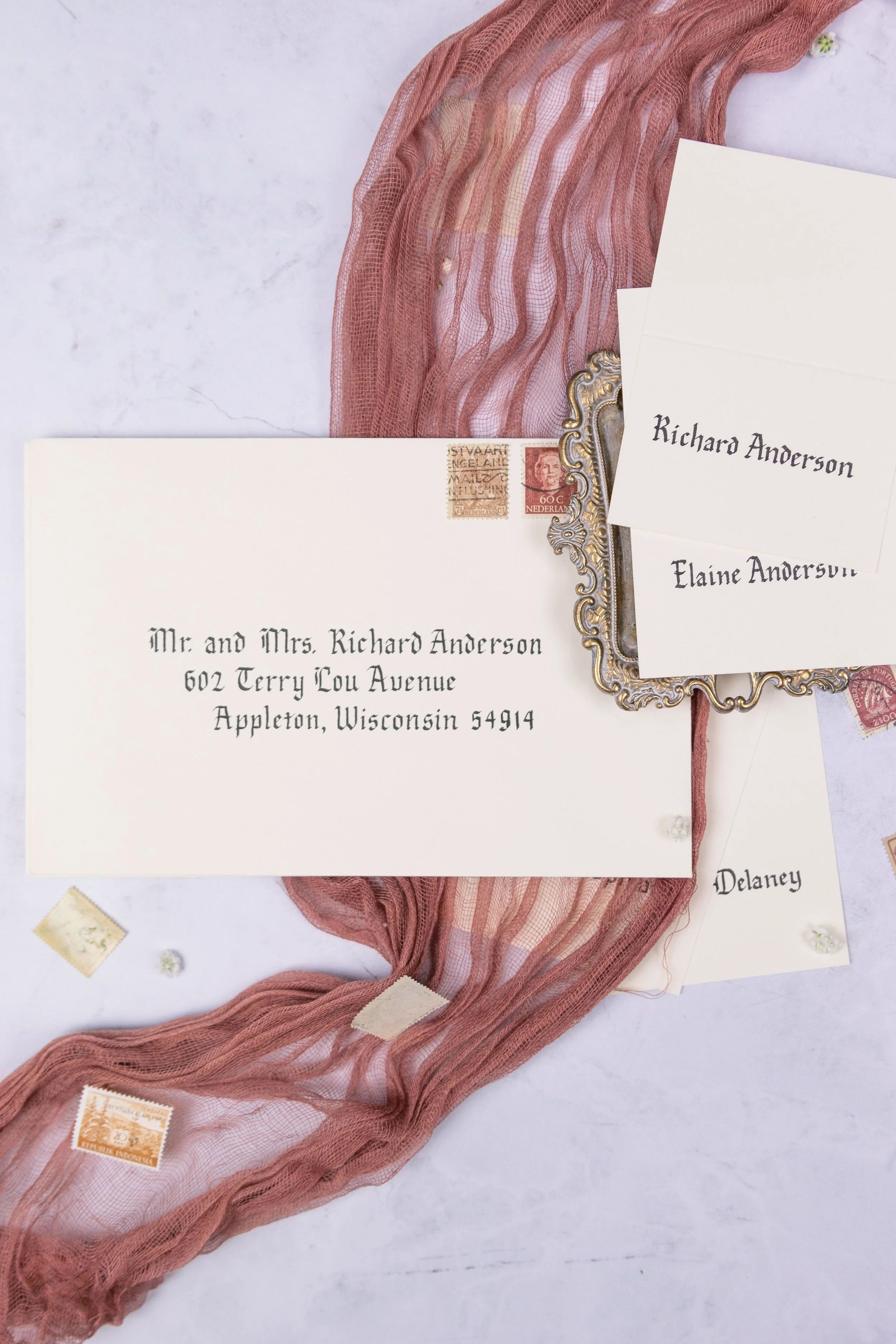 Gothic lettering on an invitations and place cards. Often combined with the use of parchment and scrolls for audiences that appreciate history.