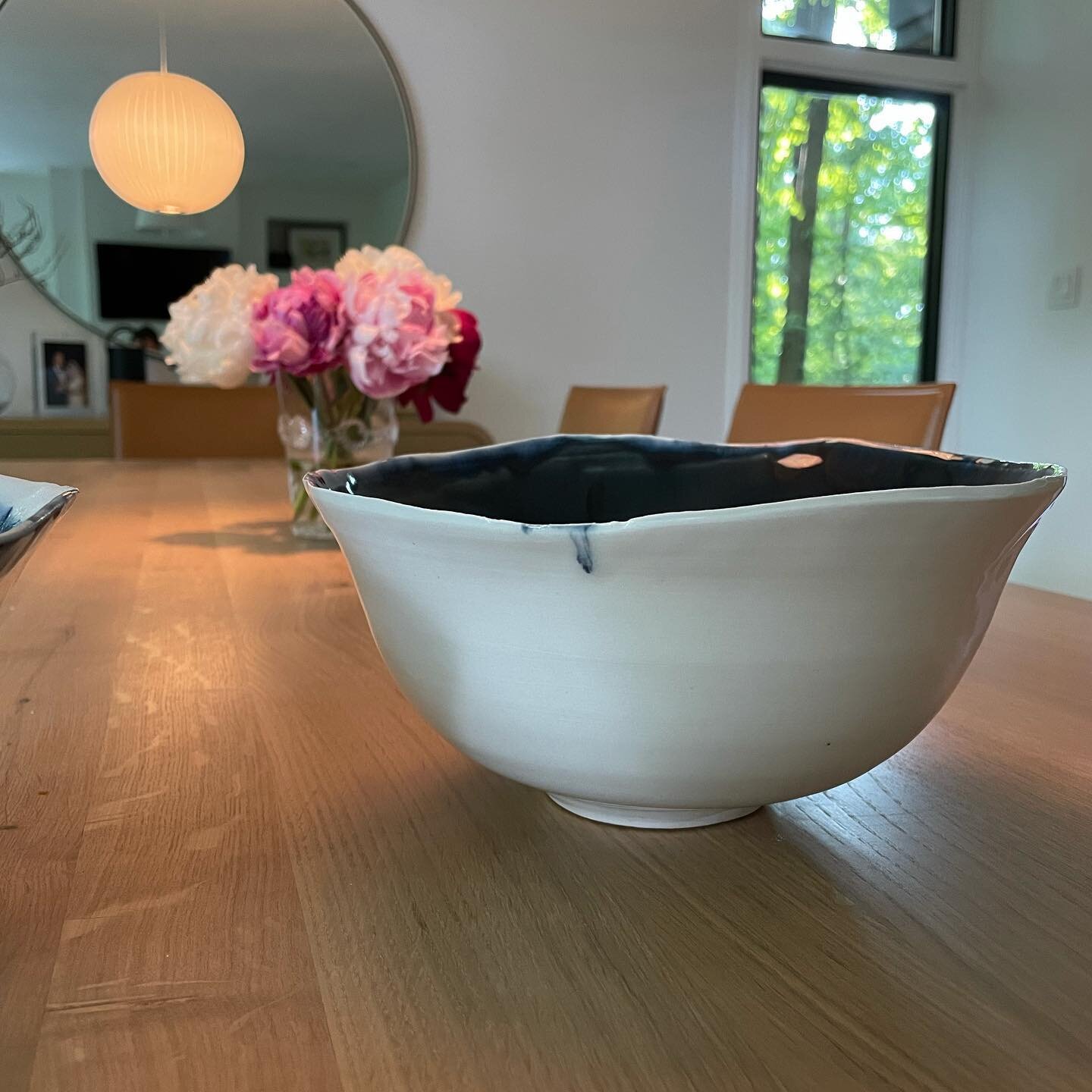 This #thrownandaltered porcelain bowl was custom made and glazed for a very special mom for mother&rsquo;s day. The interior is blue/black.