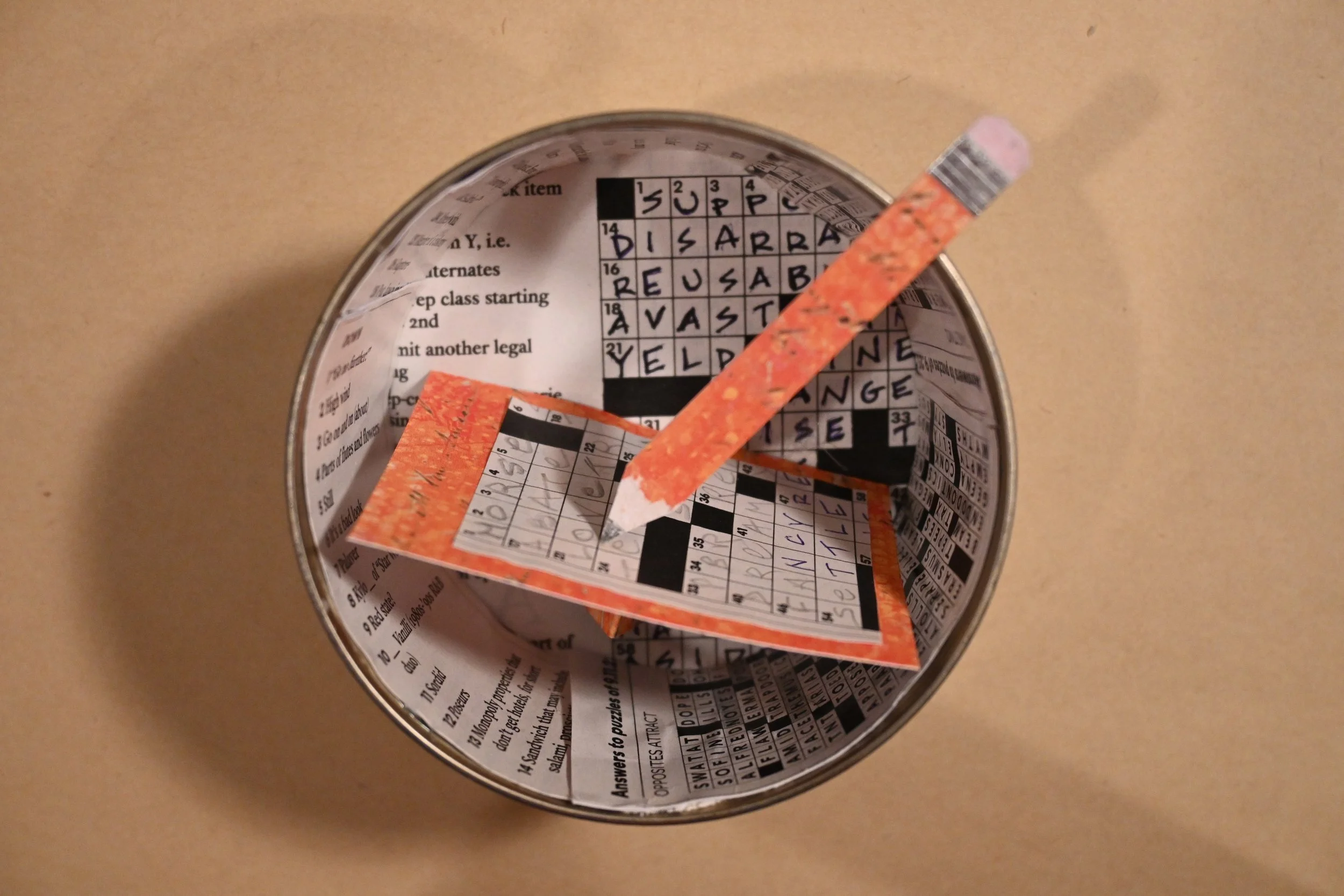 
"Canned Crosswords" (metal can, paper, foil, ink)