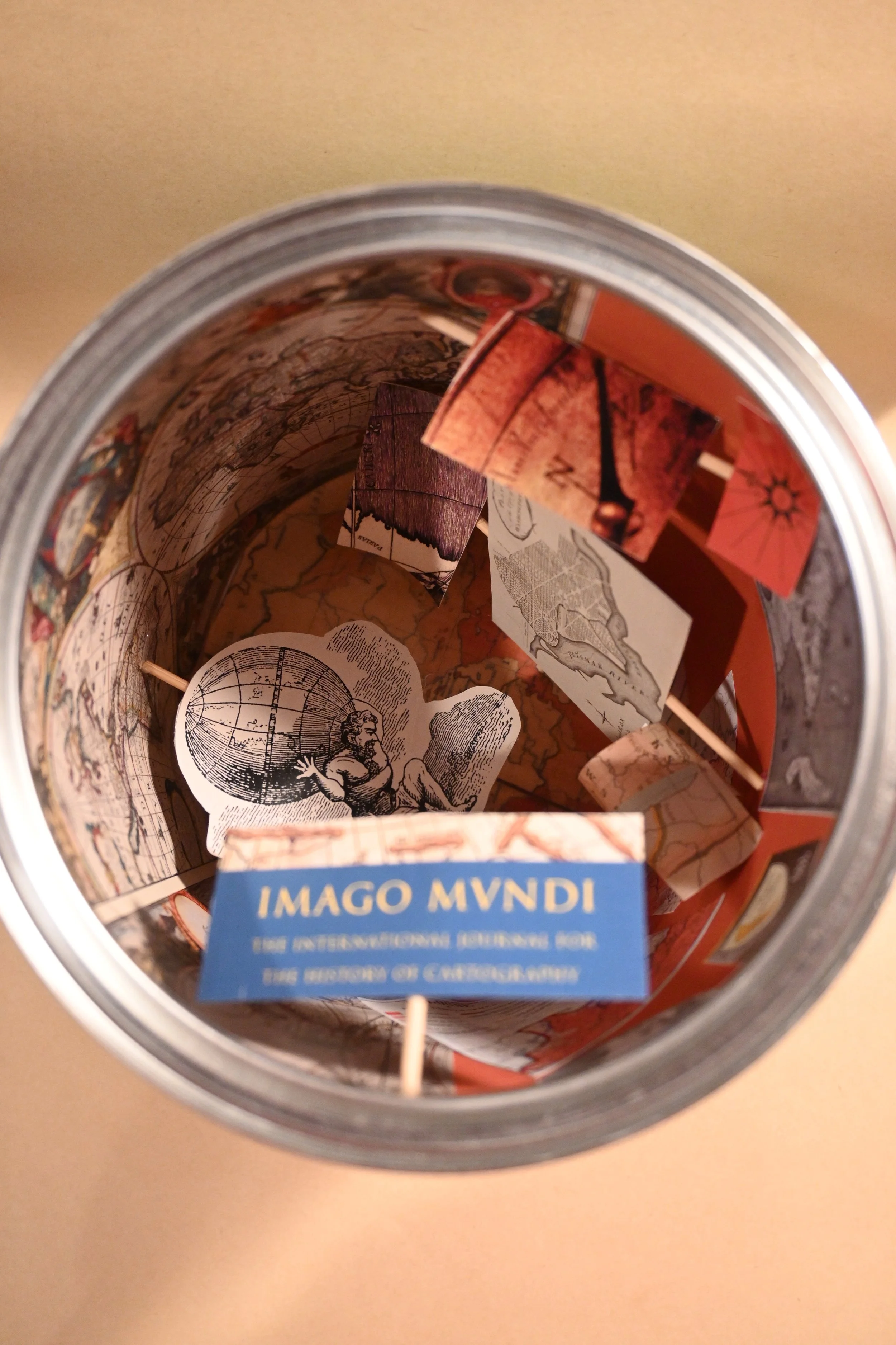 
"Canned Cartography" (metal can, paper, wood)