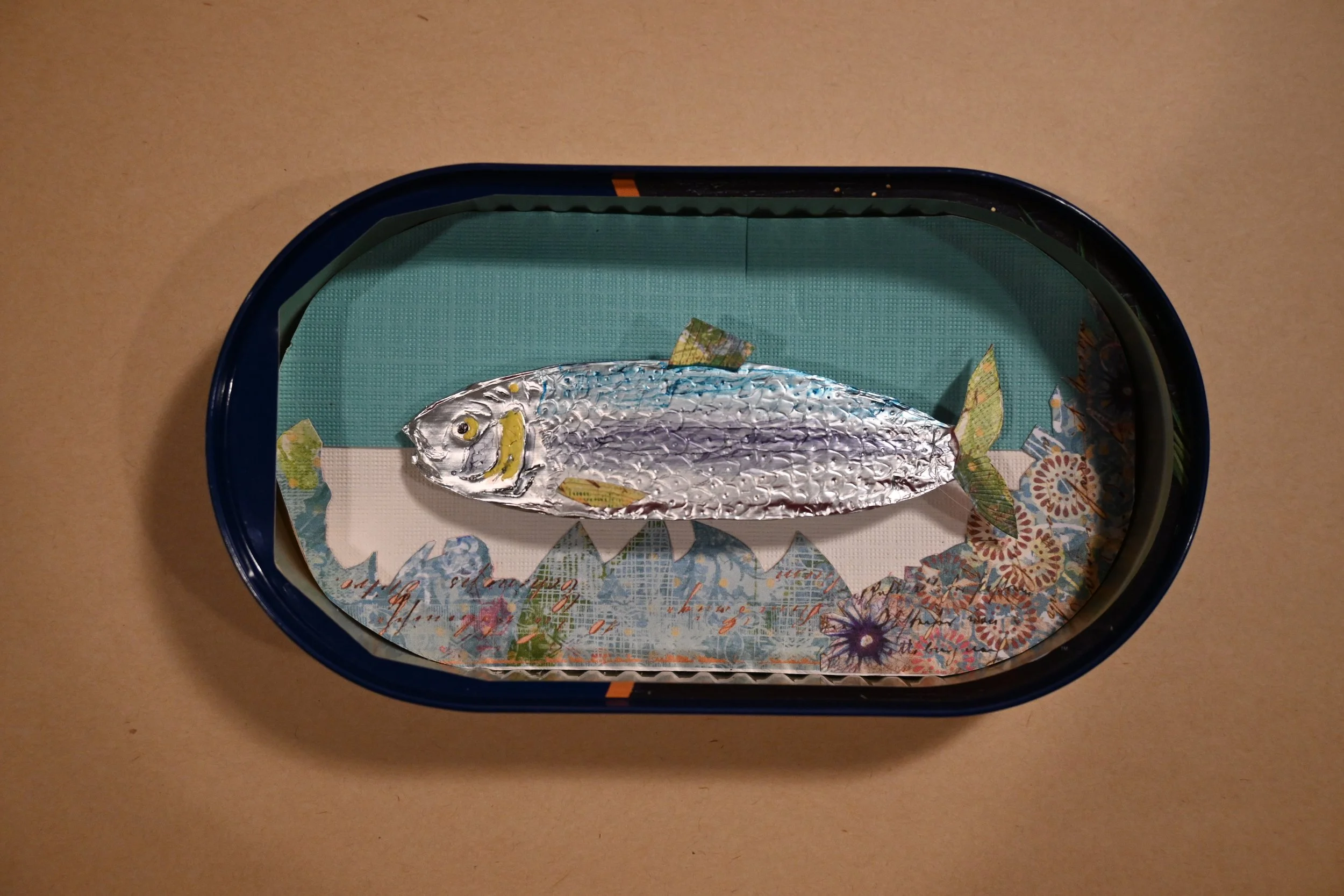 "Canned Herring In A Can, Of Course" (metal can, paper, foil, ink)