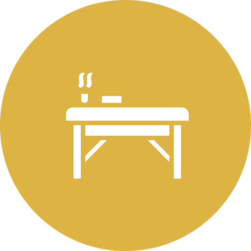 A white icon of a steaming meal on a table with a small container or utensil, set against a yellow circular background.