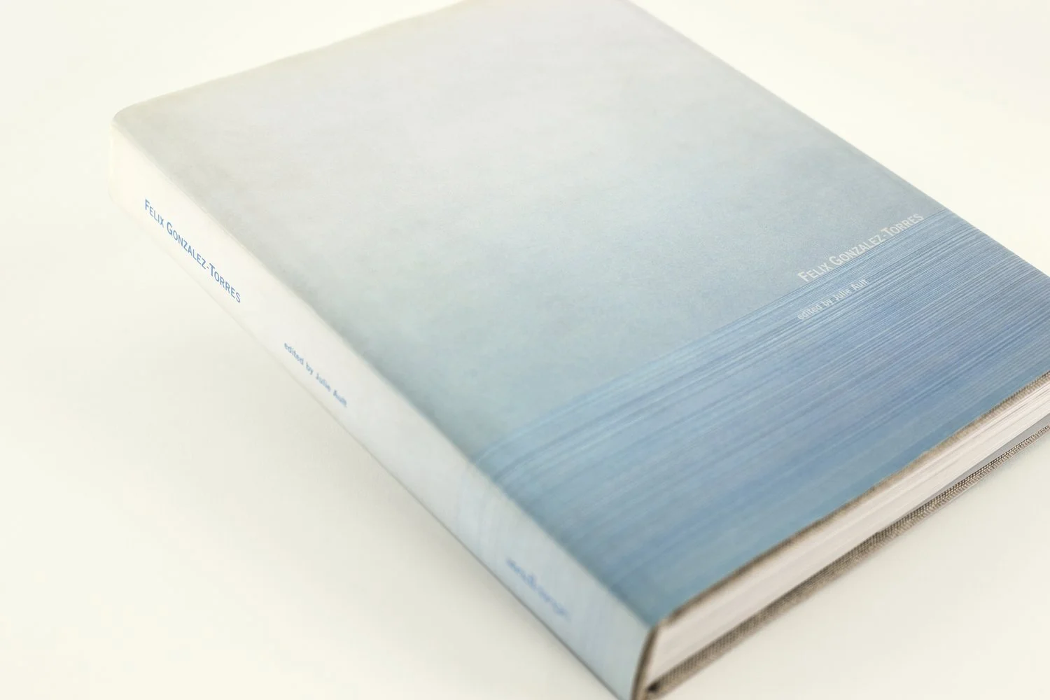 A hardcover book with a gradient blue cover by Felix Gonzalez-Torres, displayed on a white surface.