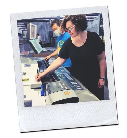 Karine Igle signing approval on the press sheet for the At Work book by Annie Leibovitz