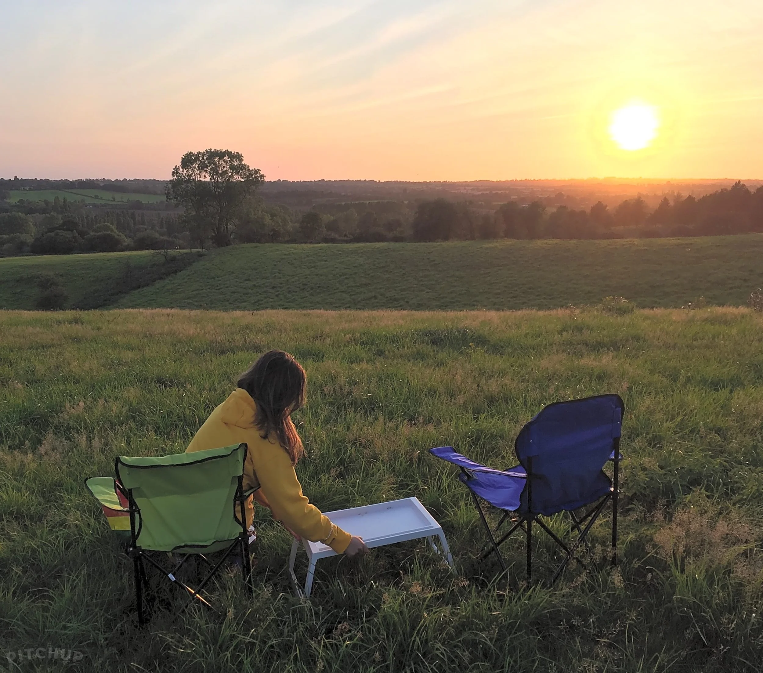 Campers on the hill at sunset