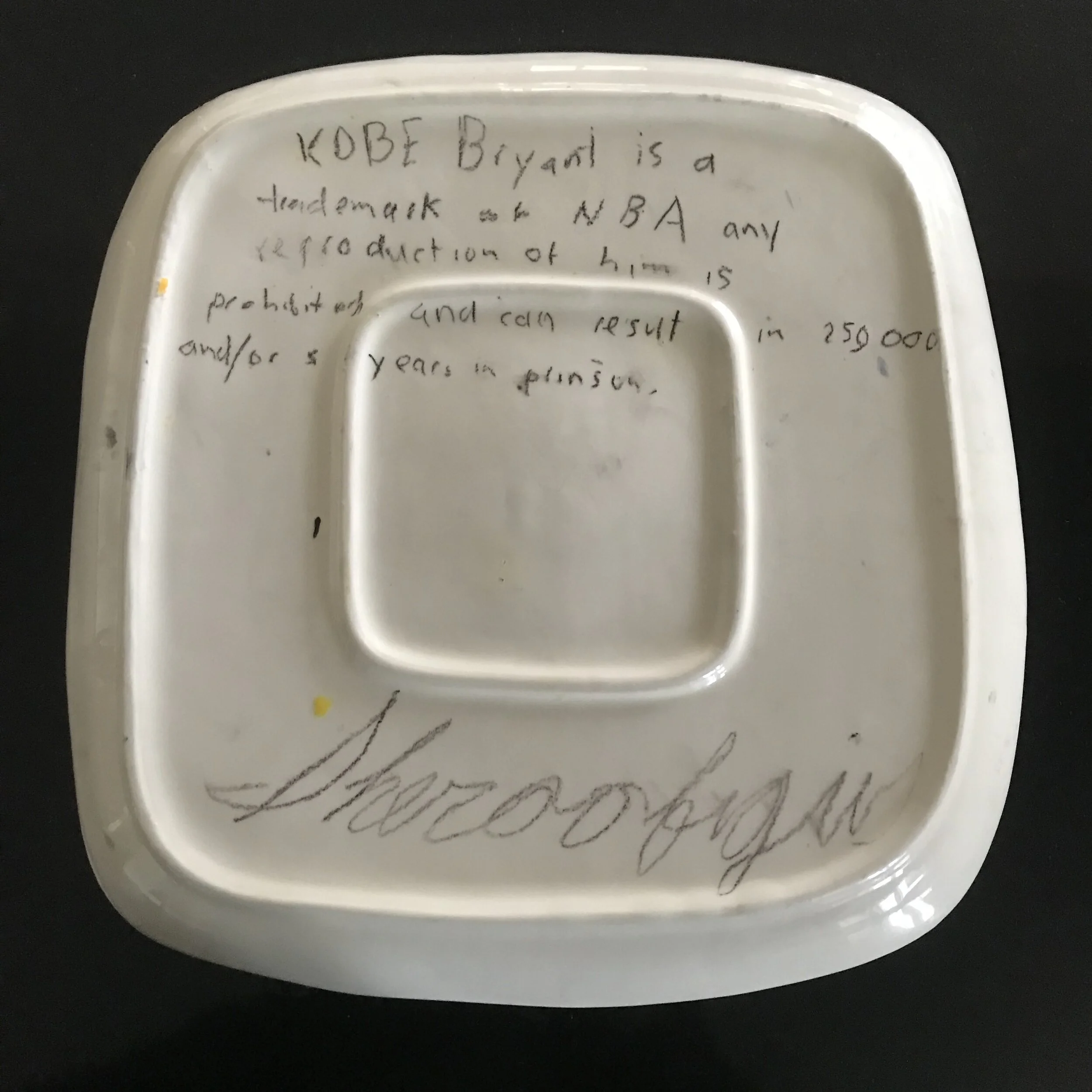 Back of hand-painted ceramic plate. Equipped with legalese describing the very laws I was breaking. Signed as my nickname given to me by Rebecca Fedele Sheroofigus.