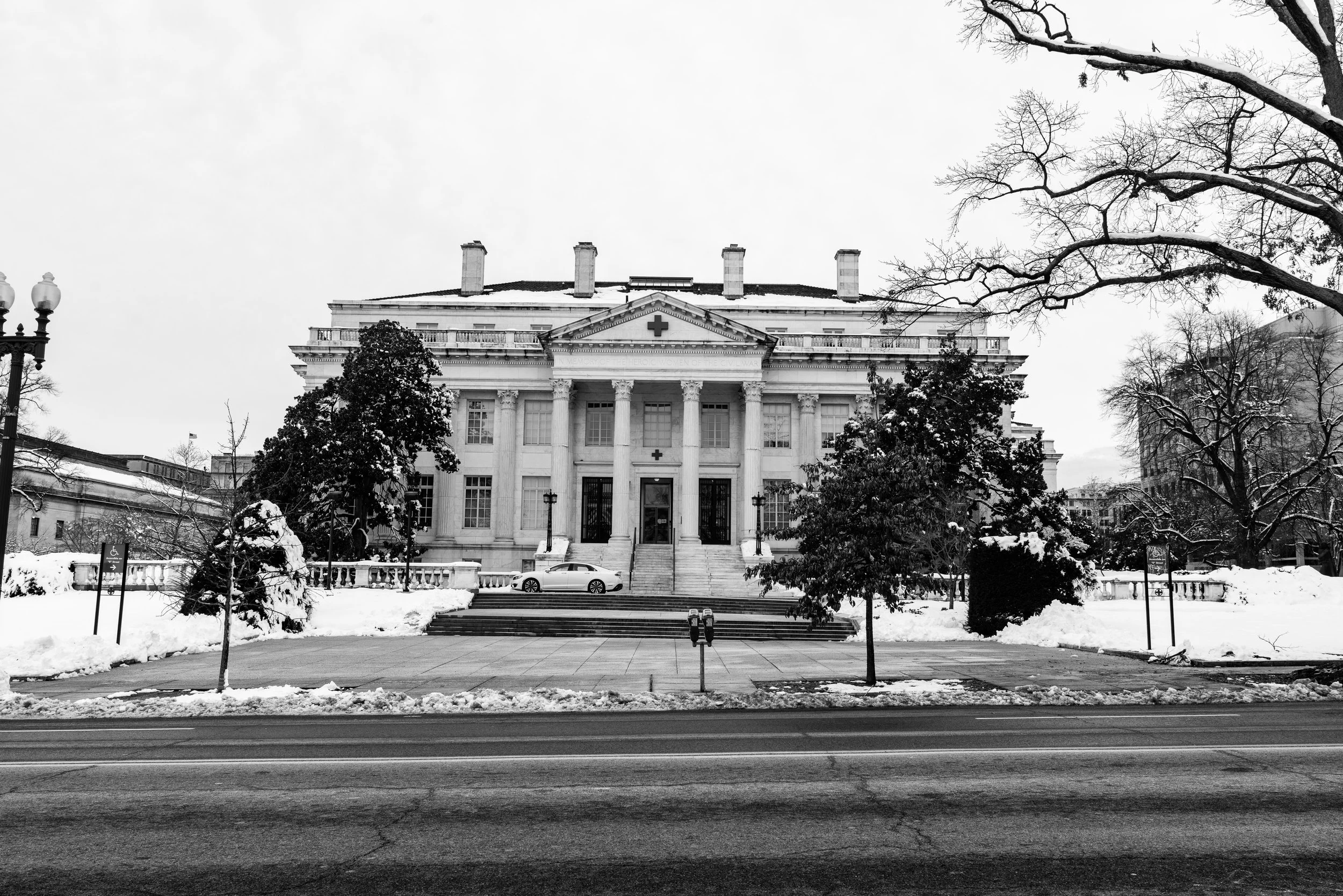 A black and white image of a building across from The White House.