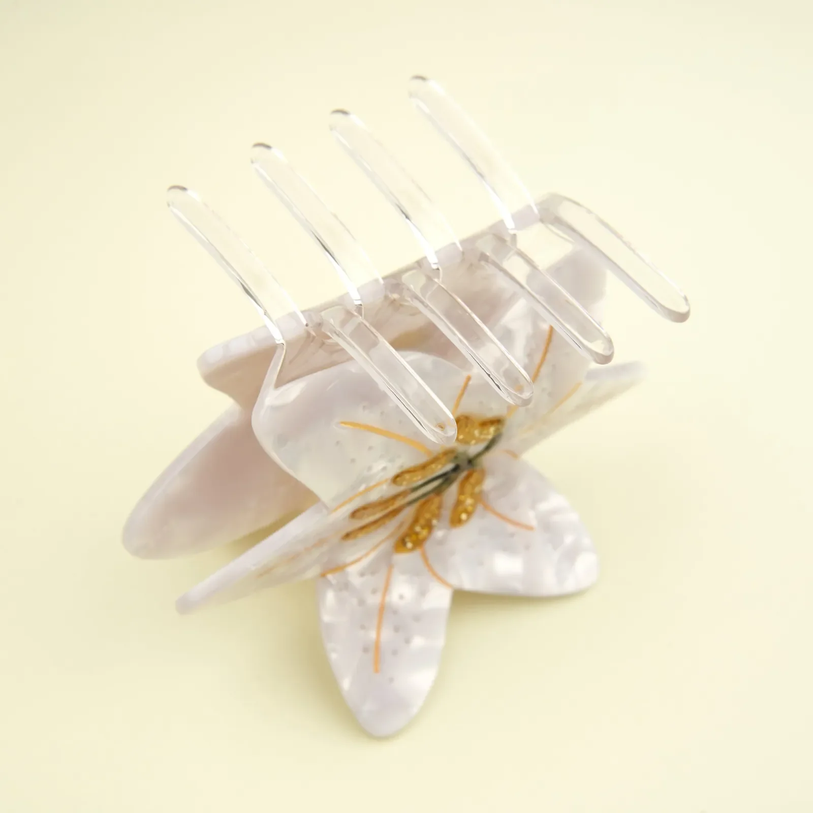 Coucou Suzette Lily Hair Claw in glossy cellulose acetate, an elegant French flower hair accessory curated by Goosebump.