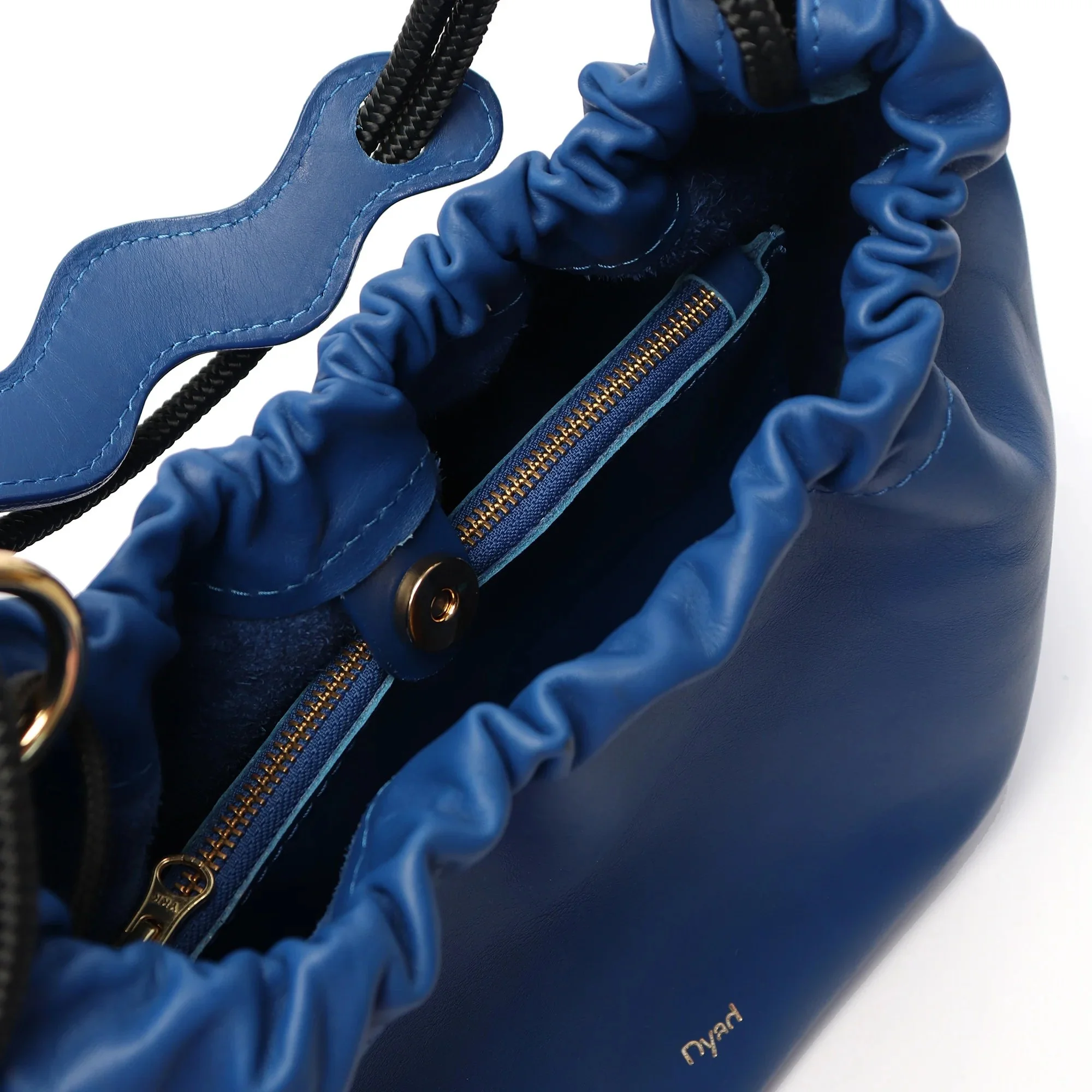 Bold cobalt blue Flora Bag with tulip-style shape and handcrafted leather detail by Project Dyad.