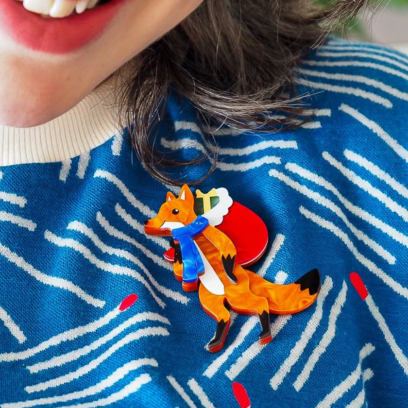 Erstwilder Freddy the Fox Brooch with layered amber resin, red gift sack, and winter scarf. Perfect festive accessory for Hong Kong brooch lovers and whimsical gift givers.