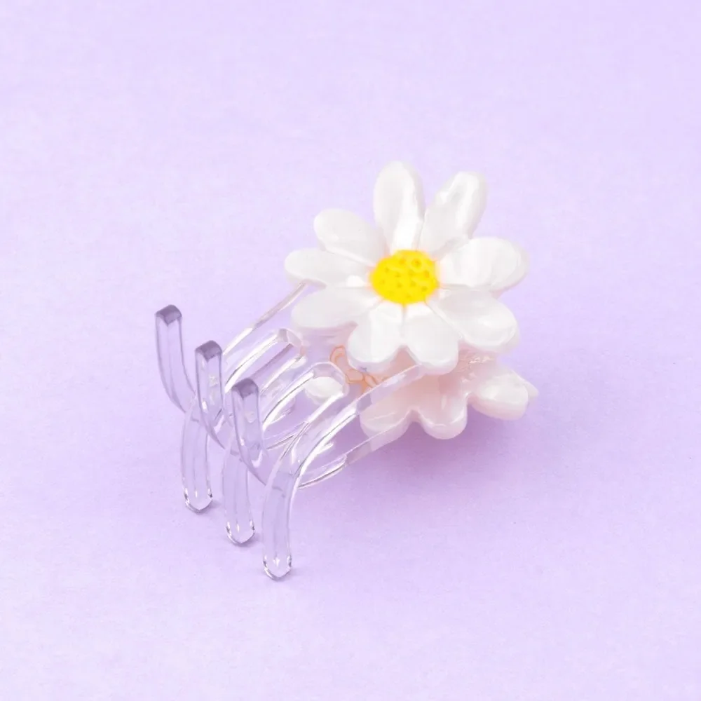 Coucou Suzette Mini Daisy Hair Claw in glossy cellulose acetate, a sweet French flower hair accessory curated by Goosebump.