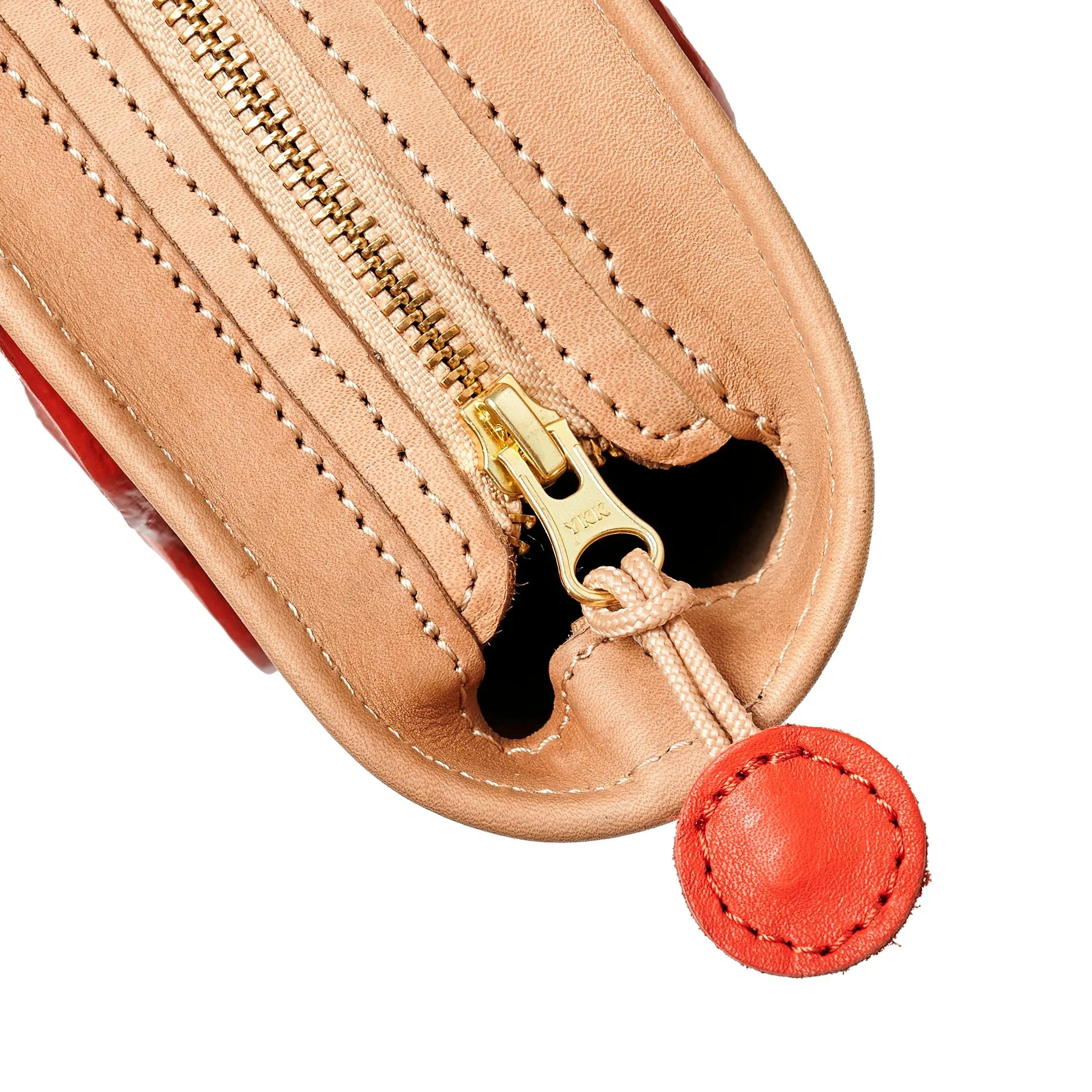 Almond and lobster red Emele Bag by Project Dyad, handmade in Cape Town with a curved silhouette and structured pleats.