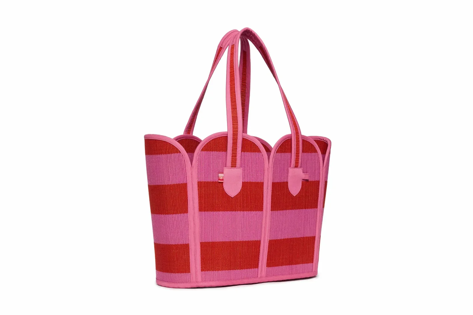 Model holding the Lorna Murray Berry Bomb Vacation Tote, highlighting its generous size and vibrant handcrafted woven design.
