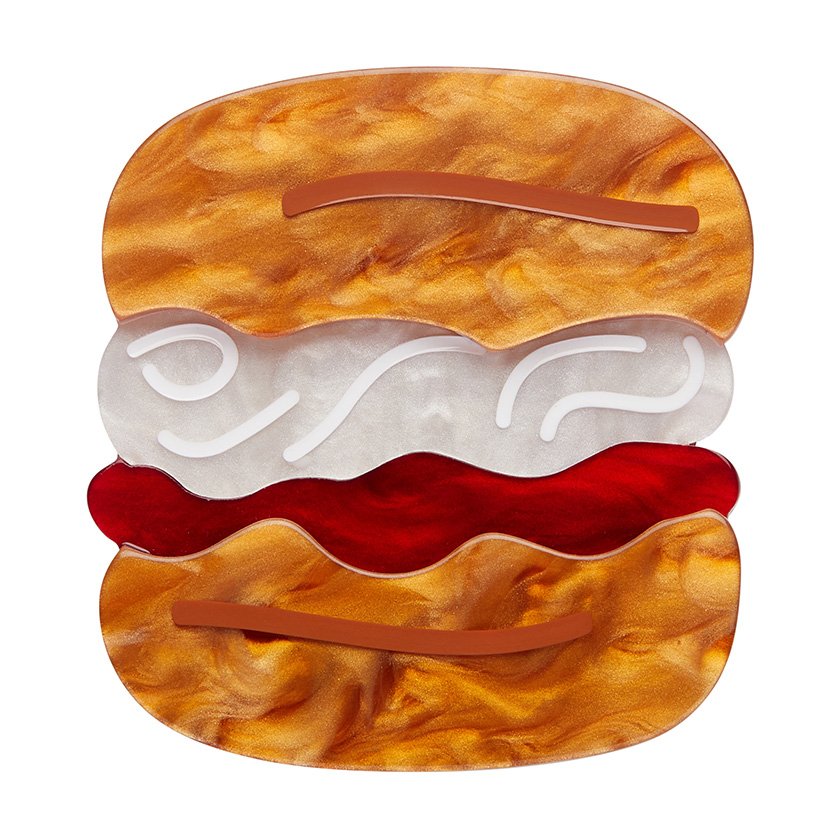 The Great British Scone Brooch, featuring a layered scone design with caramel and pearl resin details, from Erstwilder’s London Calling collection.