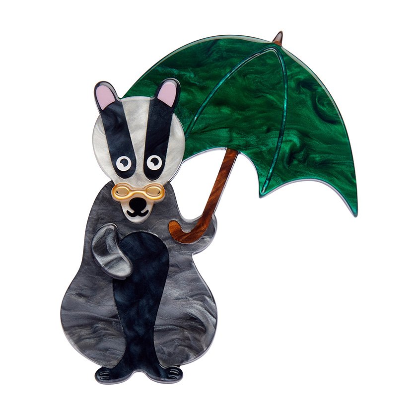 Bill the Badger Brooch featuring marbled resins in black, grey, and green with a whimsical design of a badger holding a green umbrella. Perfect for Anglophiles and Erstwilder collectors.