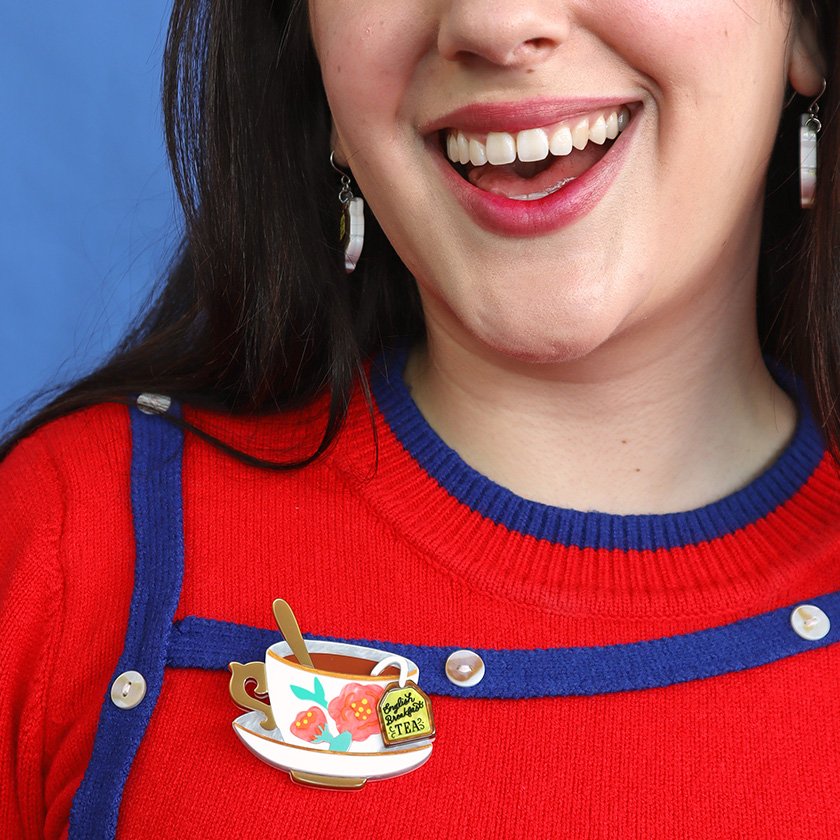 Fancy a Cuppa Brooch featuring a floral-adorned teacup with a tea tag, hand-assembled with white and gold resin, from Erstwilder’s London Calling collection. Perfect for tea enthusiasts in Hong Kong.