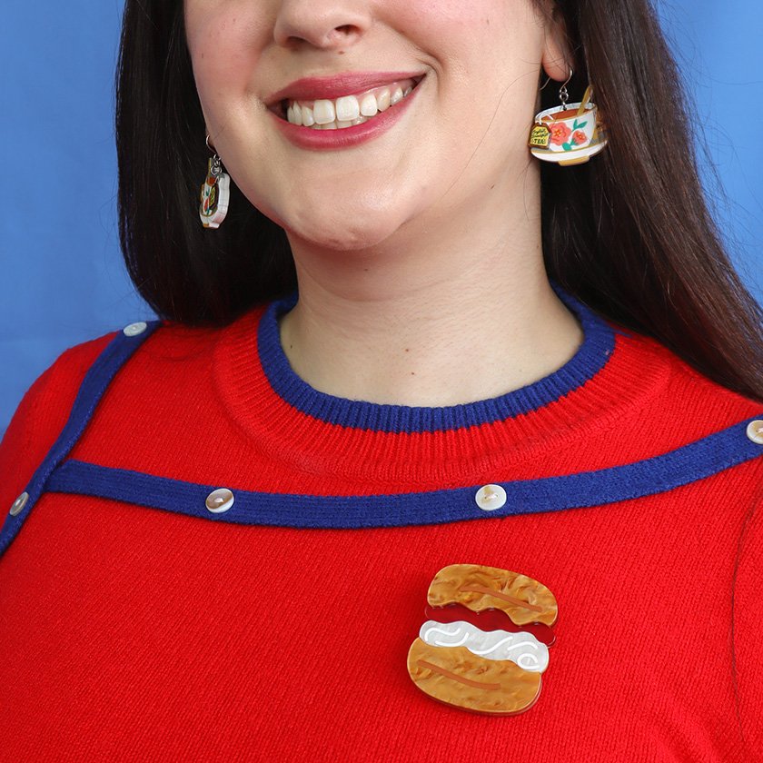 The Great British Scone Brooch, featuring a layered scone design with caramel and pearl resin details, from Erstwilder’s London Calling collection.