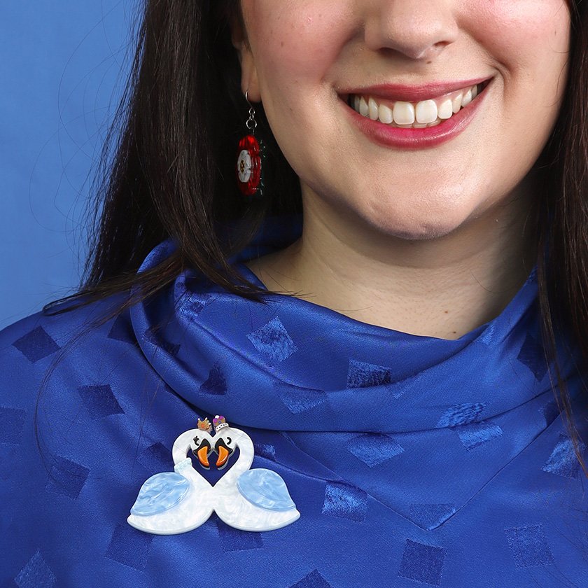 A romantic Swan Love Brooch featuring white and blue textured resin, heart-shaped swans, and crown accents. Part of Erstwilder's London Calling collection, perfect for brooch collectors in Hong Kong.