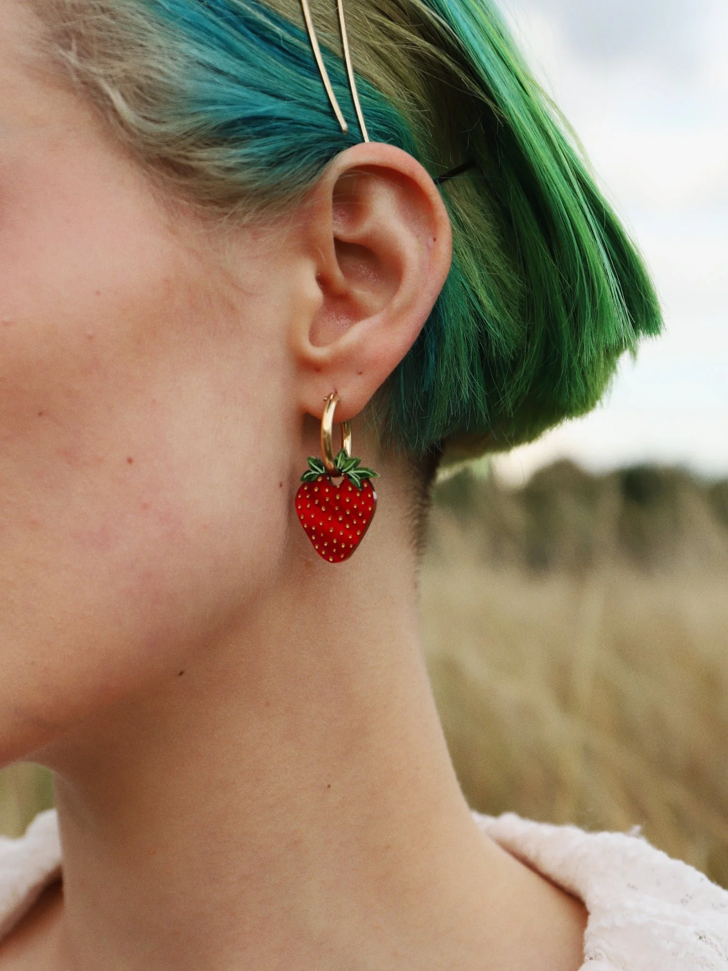 Wolf & Moon 草莓 II 吊環，配有紅色草莓飾件與金色圈形耳環。.