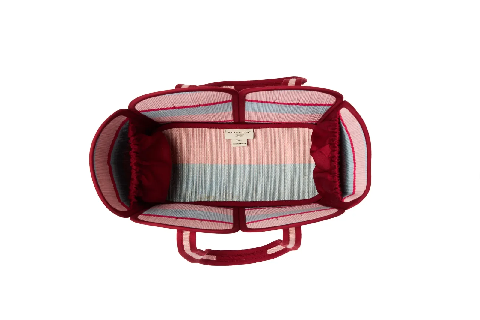 Side profile of the Lorna Murray Escape Vacation Tote highlighting its structured woven silhouette.