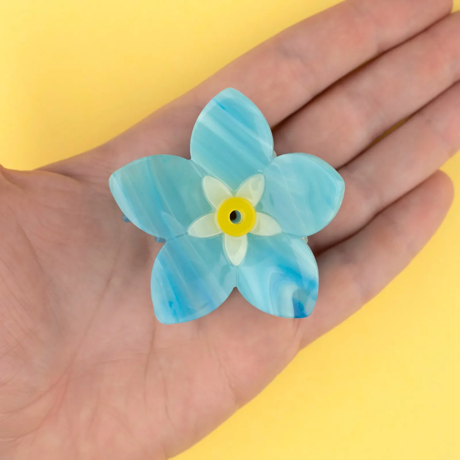 Coucou Suzette Forget-Me-Not Hair Claw in glossy cellulose acetate, a delicate French flower hair accessory curated by Goosebump.