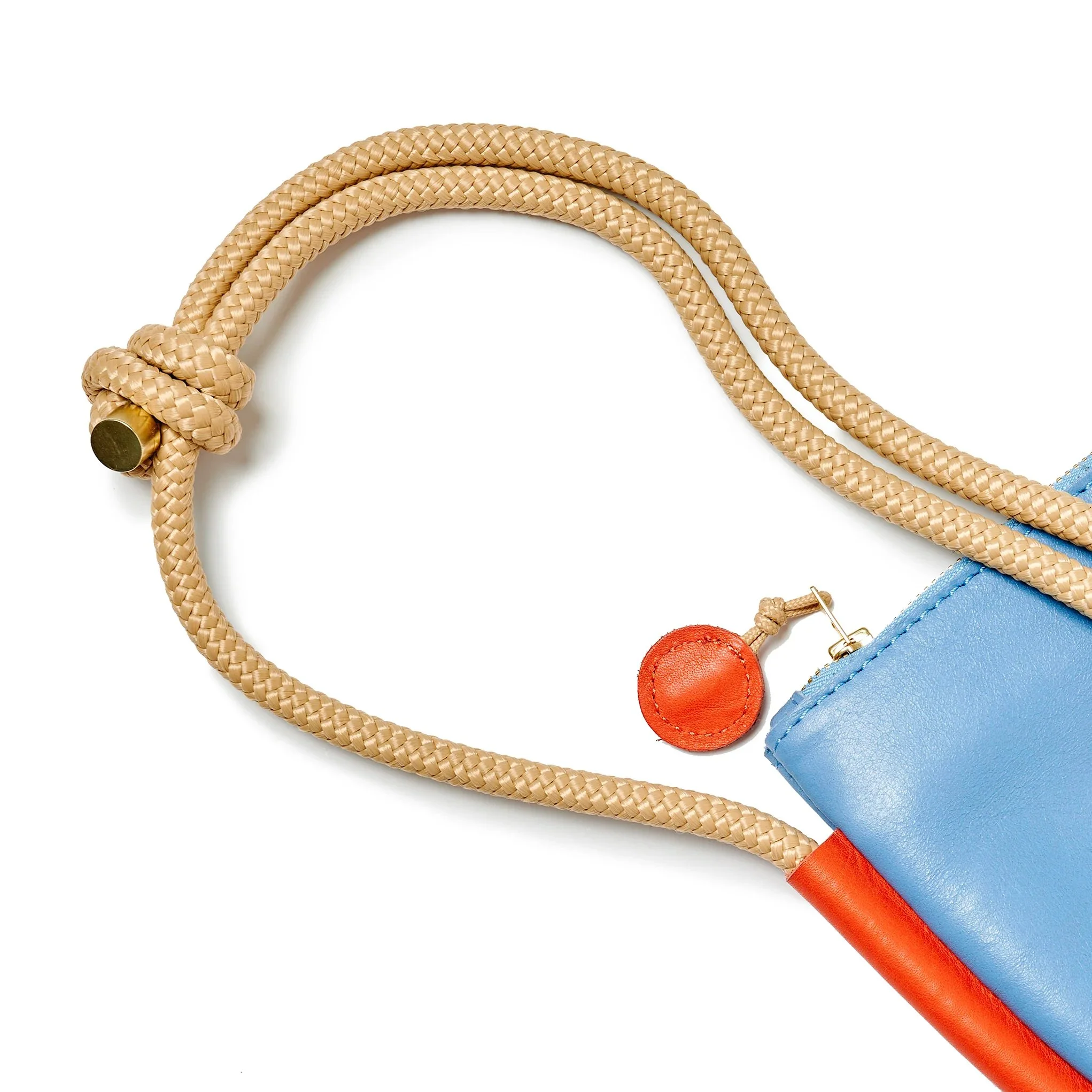 Selene Bag in sky blue and lobster red with folded silhouette, short handle and rope strap, handmade by Project Dyad in Cape Town.