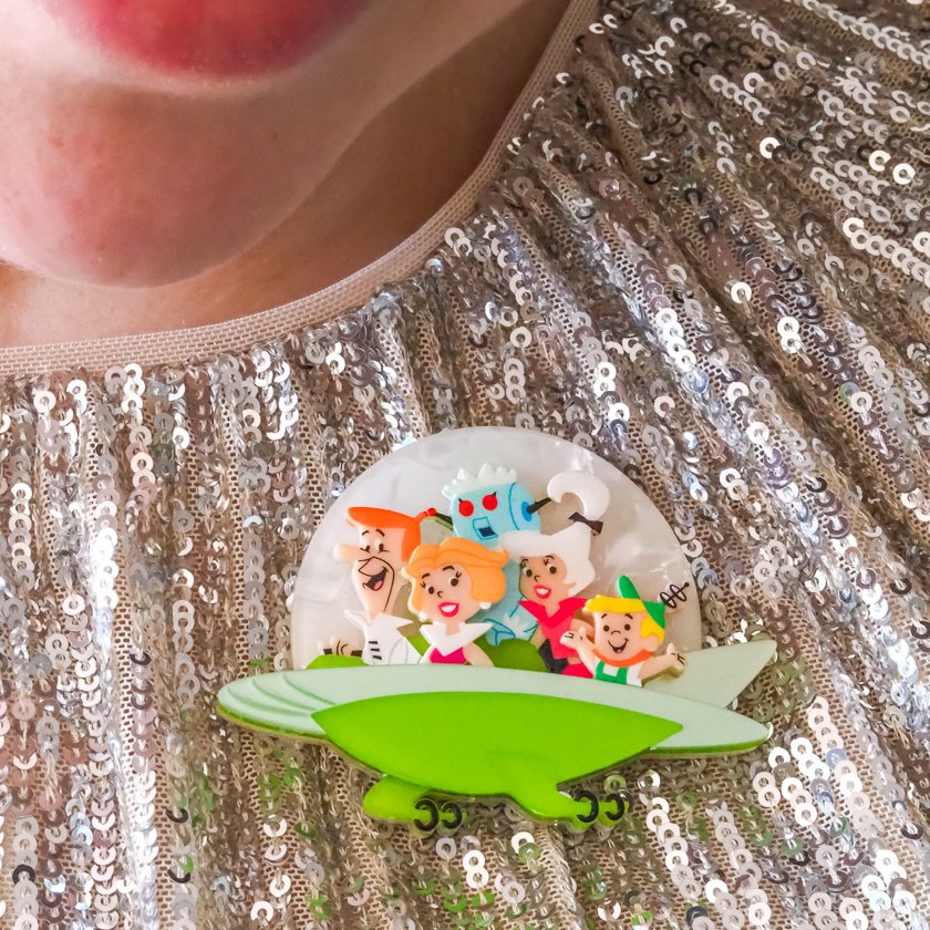 The Jetsons Aerocar brooch by Erstwilder, featuring a retro futuristic flying car design in layered resin, inspired by classic Hanna-Barbera animation.