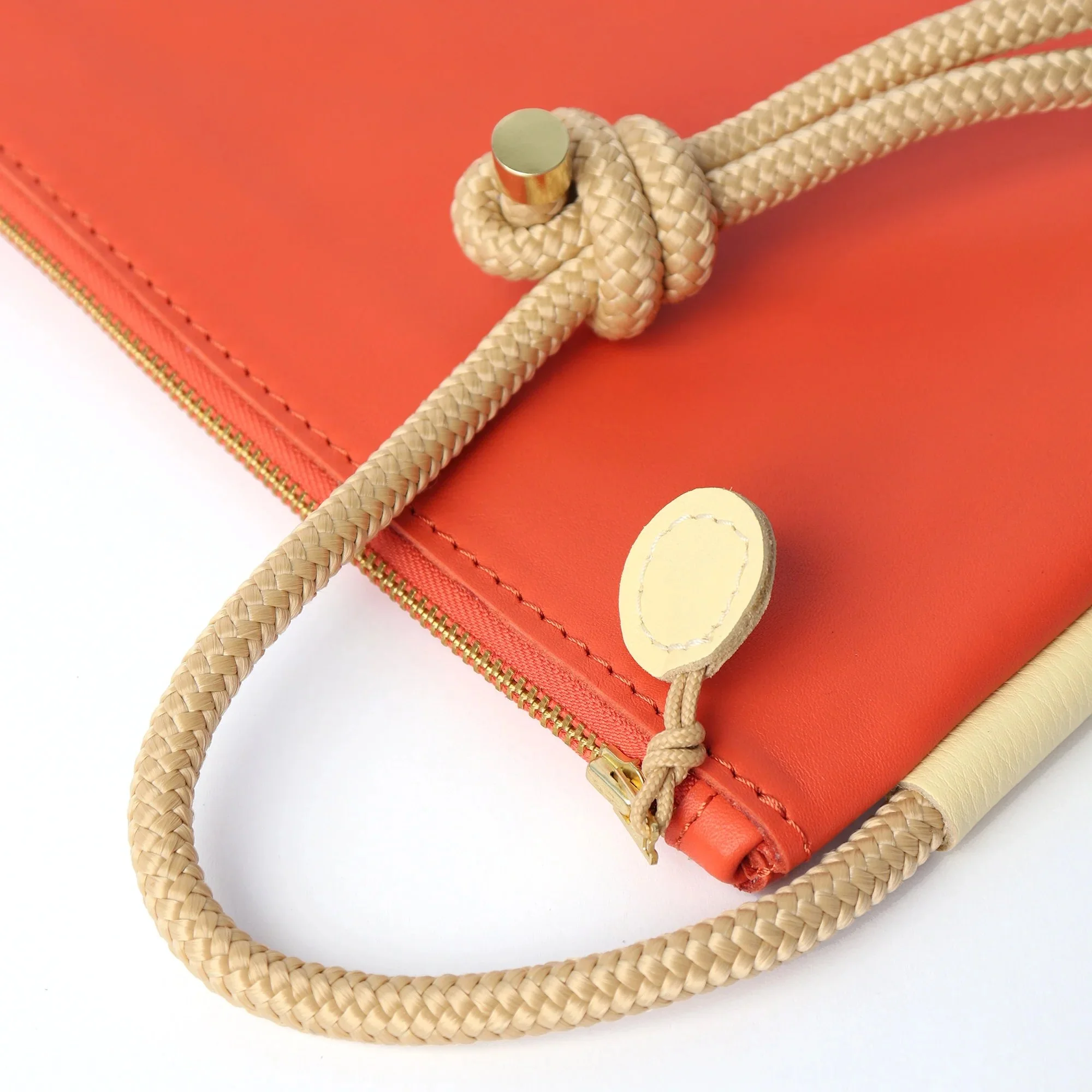Selene Bag in Lobster Red and Butter – handcrafted leather sling bag with crescent shape and adjustable rope strap, designed by Project Dyad