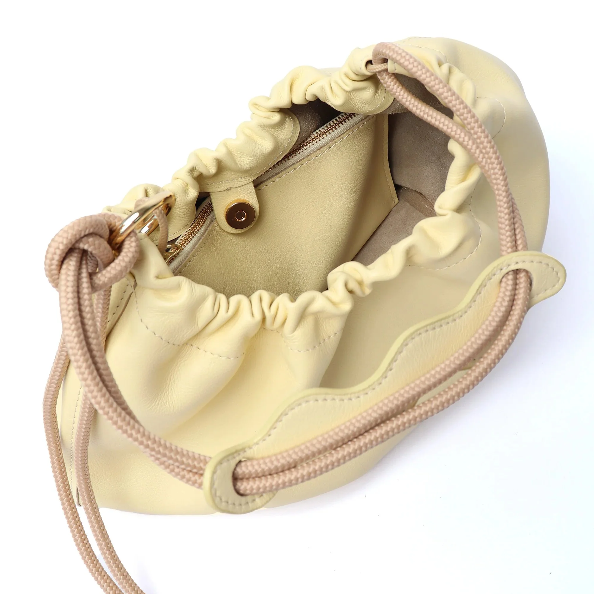 Butter yellow Flora Bag with tulip-style opening, handcrafted leather and adjustable rope strap by Project Dyad.