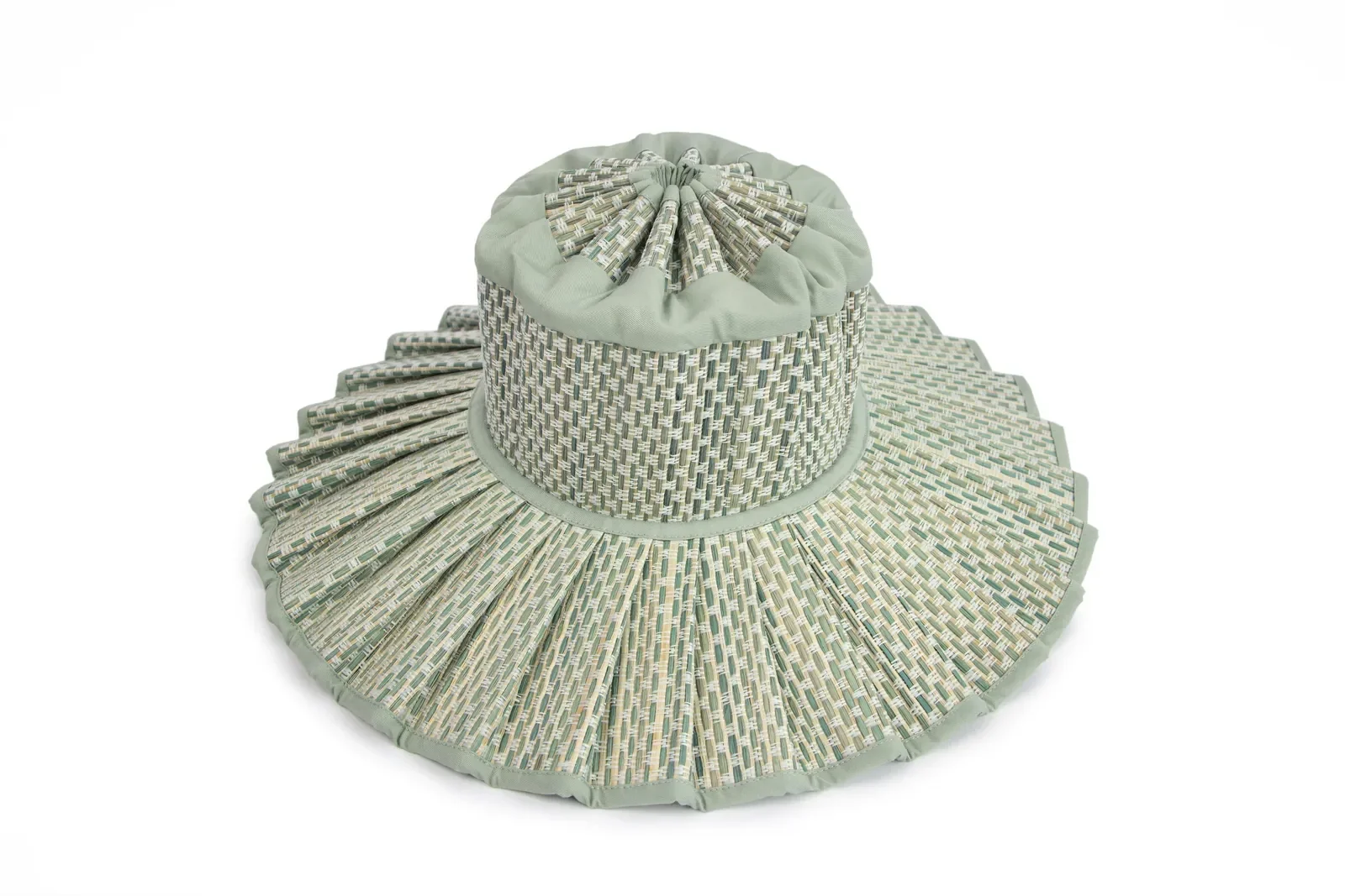 Model wearing the Lorna Murray Fiji Capri Hat with a shoulder bag, showcasing its lightweight woven design and holiday-ready style.