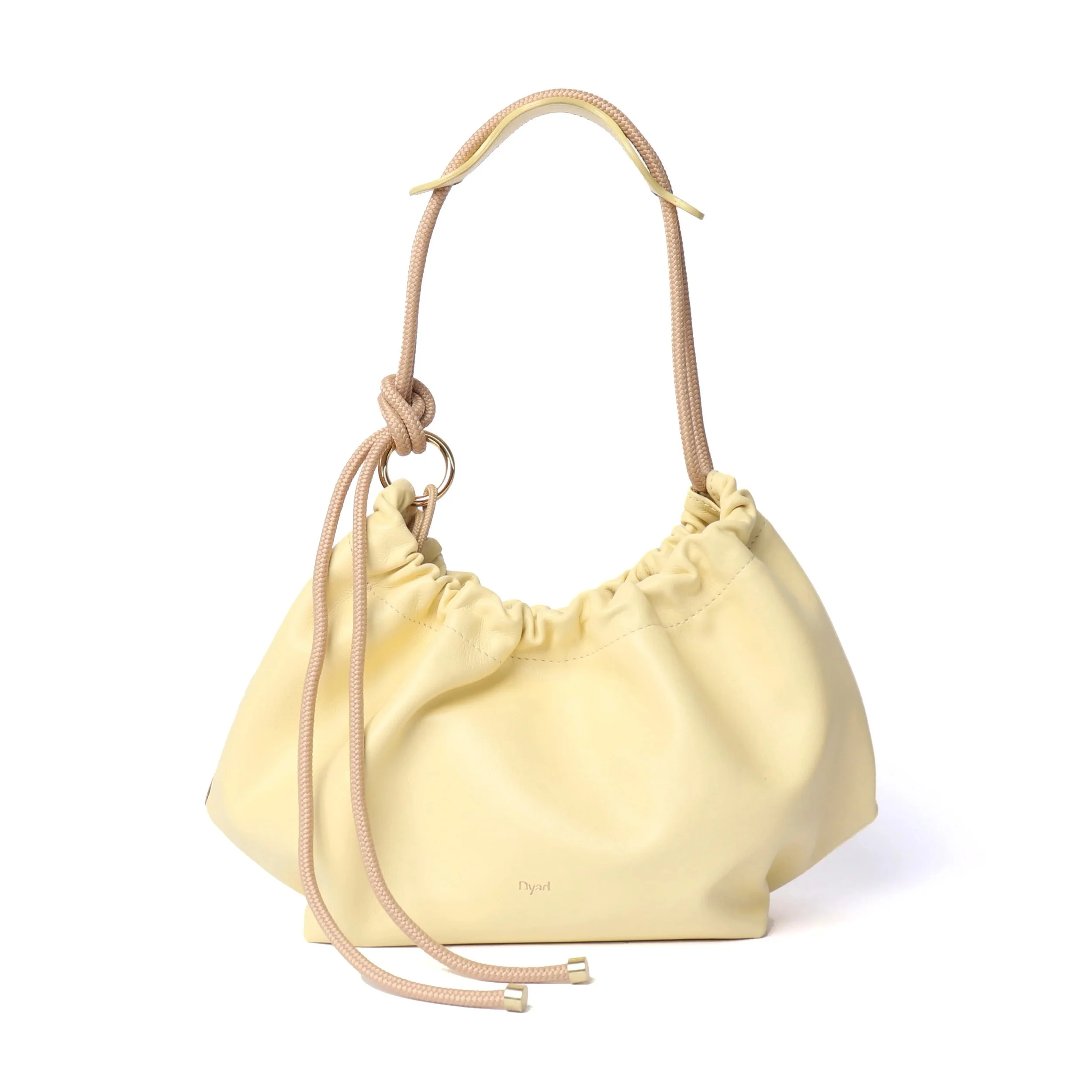 Butter yellow Flora Bag with tulip-style opening, handcrafted leather and adjustable rope strap by Project Dyad.