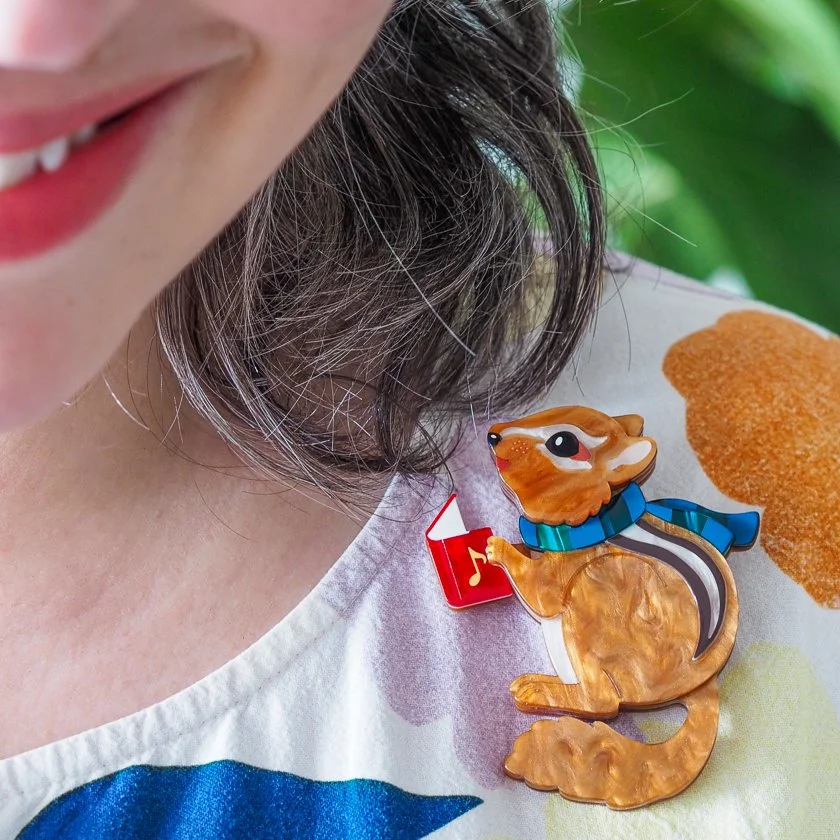 Erstwilder Charlie the Chipmunk Christmas brooch with scarf and carol book, layered resin design. Exclusive in Hong Kong at Goosebump.