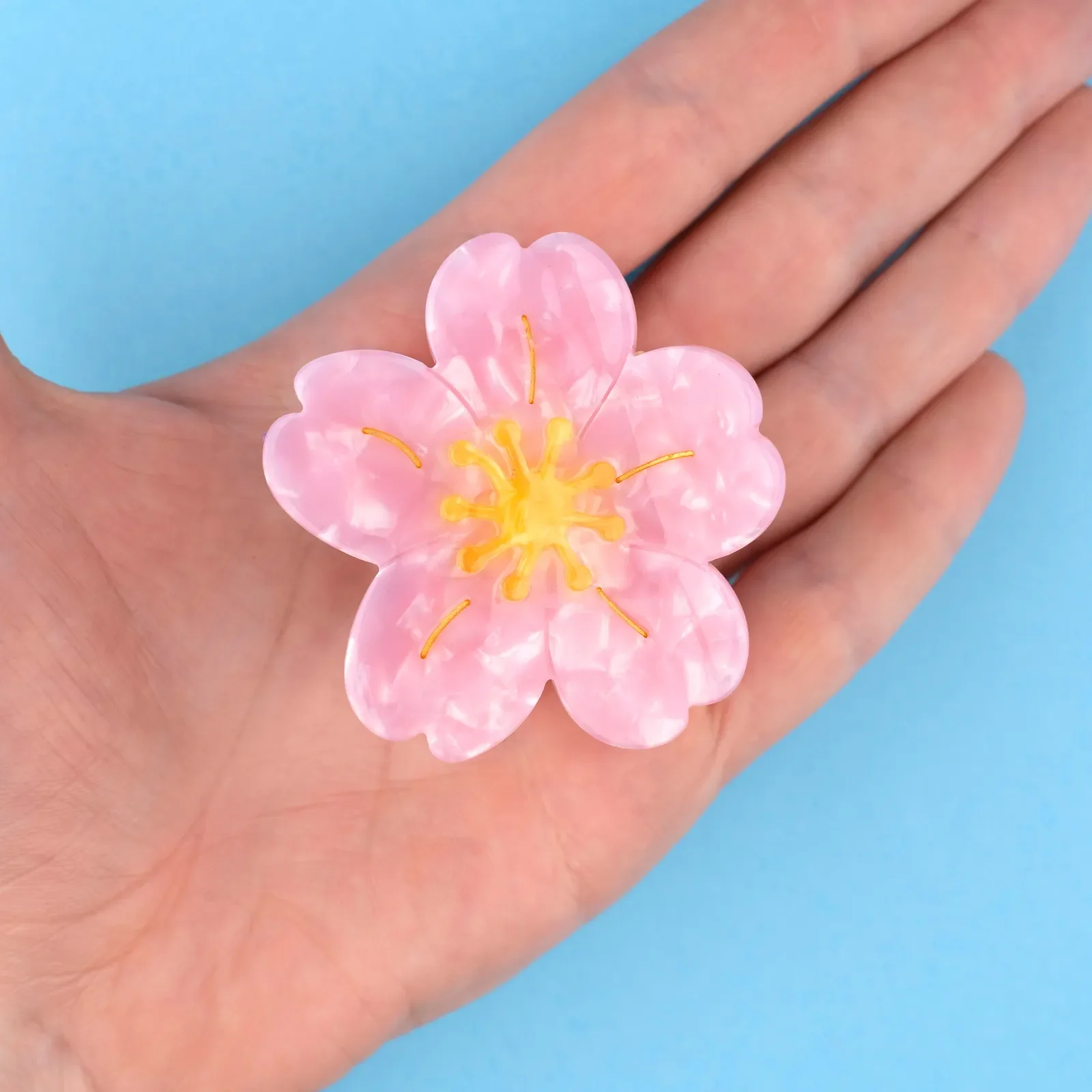 Coucou Suzette Sakura Hair Claw in glossy cellulose acetate, a delicate French flower hair accessory curated by Goosebump.
